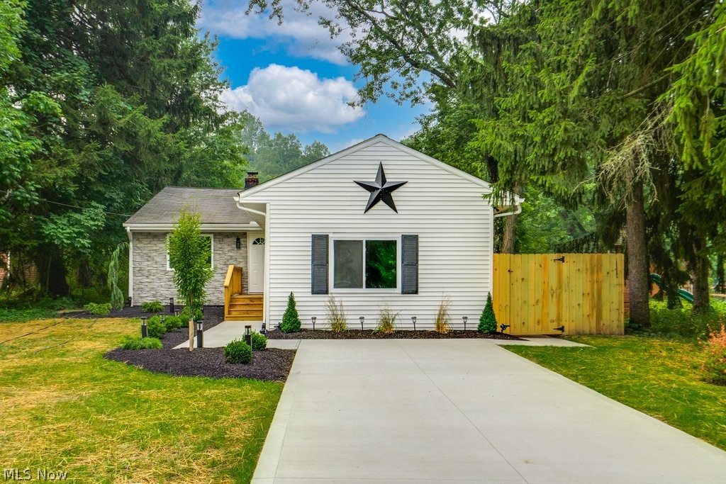 Prepare to be blown away by this beautiful 3 bedroom home in the great city of North Royalton! This home is situated on .93 acres of land and conveniently located near shops, schools, and restaurants. Upon entering, you are first welcomed into a large open-concept family and dining room, and kitchen, all updated with brand new floors and paint. This show-stopping kitchen is updated with brand new shaker white cabinets, backsplash tiles, modern light fixtures, and beautiful Granite countertops with a waterfall slab running down the counter! There are 1.5 full baths on this level, completely upgraded with new vanities, beautiful floors and fixtures, tiled showers, and a lovely French Tub! Additionally, you will find 3 spacious bedrooms with lovely tall ceilings in each room and brand new carpet. In the lower level of this home, you first walk into a recreational room perfect for entertaining and then the utility room equipped with wash/dryer hookups, a cost-effective electric furnace, and door that leads into a fully fenced-in backyard! The exterior of the home is nicely dressed in decorative gray stone and beautiful white vinyl siding, brand new concrete driveway and parking pad for easy maneuverability, and gorgeous new landscaping! Make your showing today!