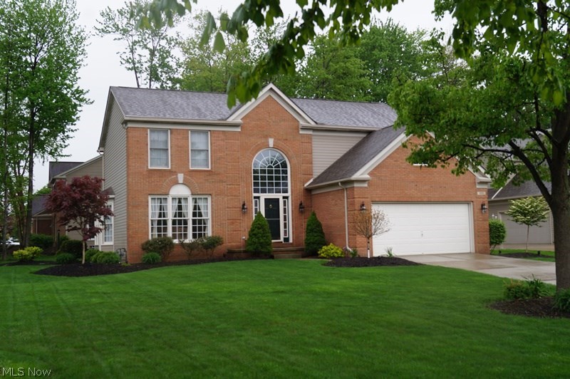 Charming Full Brick Front colonial in The Woods! Neatly landscaped and sprinklered .32 acre lot with a treed view! Bright and cheerful interior with large windows granting an abundance of natural light! 2 story foyer, enormous kitchen with spacious working island has stainless steel appliances, spacious step-down family room with wood burning fireplace, elegant dining room with bay window, vaulted Master suite has glamour bath with huge steeping tub and walk-in closet, and large nicely finished basement with glass block windows! Newer roof - sliding door - appliances - lighting fixtures - shower door - storm door - kitchen countertops - hand scraped flooring in the foyer - eat-in kitchen - living room - dining room -family room! Interior is decorated in today's popular colors and is flawless in condition, a beautiful deck overlooks private wooded rear yard, and The Woods offers access to 8 acres of green space with playground-tennis courts-soccer field and access to Kinsner Elementary!