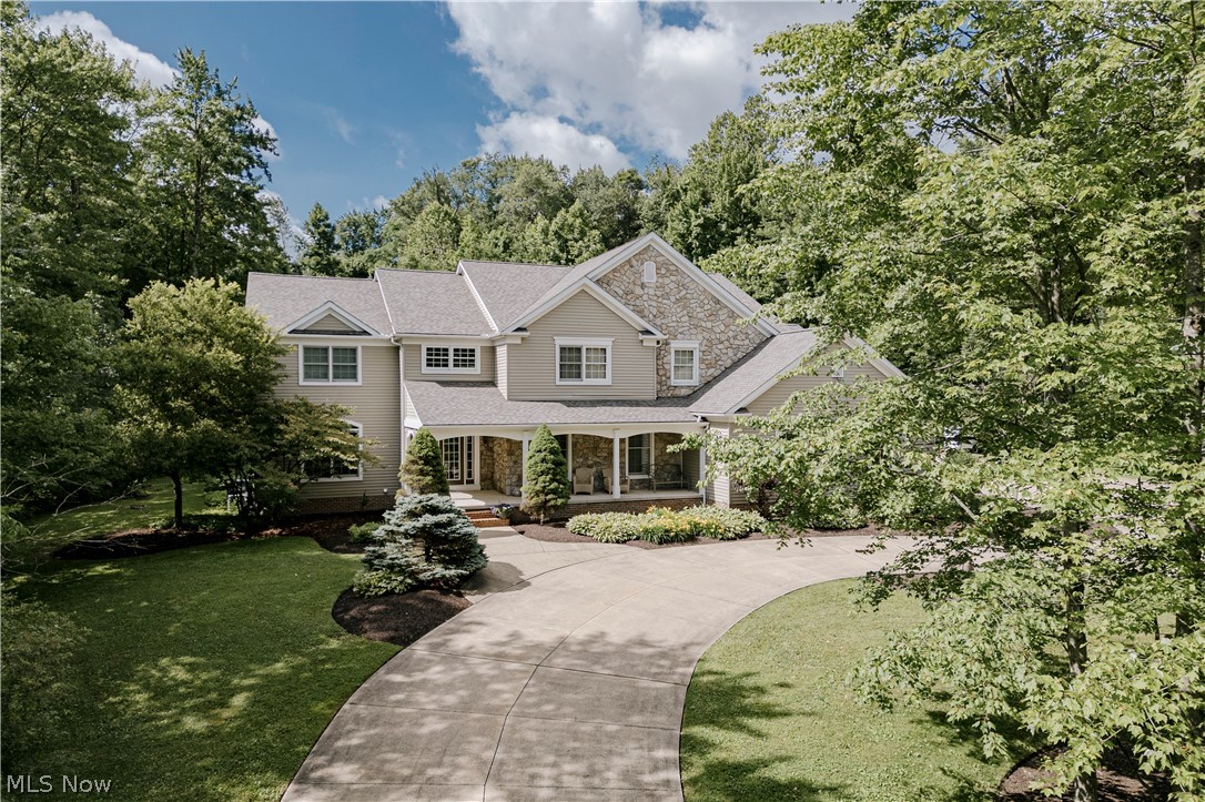 Nestled on three wooded acres on a quiet street, this extraordinary estate combines refined sophistication with the warmth of a true family home. A circular drive framed by mature trees sets the tone, leading to a residence that offers privacy, elegance, and a lifestyle of effortless comfort. Step inside and you are greeted by a dramatic two-story foyer, where gleaming hardwood floors flow throughout the main level. French doors open to a home office, while the opposite side reveals a formal dining room designed for large celebrations. The heart of the home is the expansive gourmet kitchen, perfectly crafted for both daily living and grand entertaining. With two large islands, dual sinks, granite countertops, and a generous walk-in pantry, it is as functional as it is beautiful. The adjoining sun-filled dining area and vaulted sunroom open seamlessly to the patio, creating an easy flow for indoor-outdoor living. Gather in the grand living room, where a striking stone fireplace and custom built-ins set the stage for cozy evenings and lively get togethers. Upstairs, the luxurious primary suite offers a serene retreat with vaulted ceilings, an oversized walk-in closet, and a spa-inspired bath. Four additional bedrooms, connected by Jack-and-Jill baths, provide space and comfort for family
and guests. The walk-out lower level is designed for recreation and relaxation, with a spacious family room, wet bar, game room, and a full bathroom that includes a steam room attachment for a private spa experience, plus a bonus room that doubles as a sixth bedroom. French doors open to a private patio, extending the living space outdoors to your own private sanctuary, an expansive backyard perfect for weekend gatherings and entertaining. With an attached three-car garage and a detached two-car garage with loft area, there is no shortage of space. Recent improvements include a new roof 2026, 2 new furnaces 2026, 2 newer ac units, and a whole home generator!