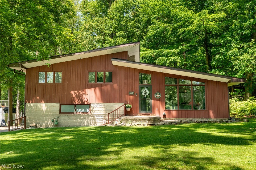 Beautiful split-level home sitting on a 1.18-acre lot has so much to offer. This unique 2,000 sq ft home has stunning architecture, and wood accents throughout. Welcomed by the great room that features a vaulted ceiling, wood beams, a wood-burning fireplace, and an abundance of natural light. The open-concept great room leads to the eat-in kitchen. The spacious kitchen has cabinets galore, stainless steel appliances, hardwood floors, a tile backsplash, and a walkout to the back patio great for entertaining friends & family. The wooded backyard is perfect for relaxing and spending time outdoors. The Lower level features an office space, a family room with a brick fireplace, a full bathroom, and a laundry/mudroom combo with exterior access. Upstairs offers three bright bedrooms with stunning hardwood floors, and another full-size bath with a large double vanity, an oversized mirror, and a tiled tub shower combo. One of the bedrooms has a second fireplace with a large mantle. Completing the package are the attached 2-car garage and the detached 3-car (33x21) garage. A must-see! Make an appointment for your private showing today!