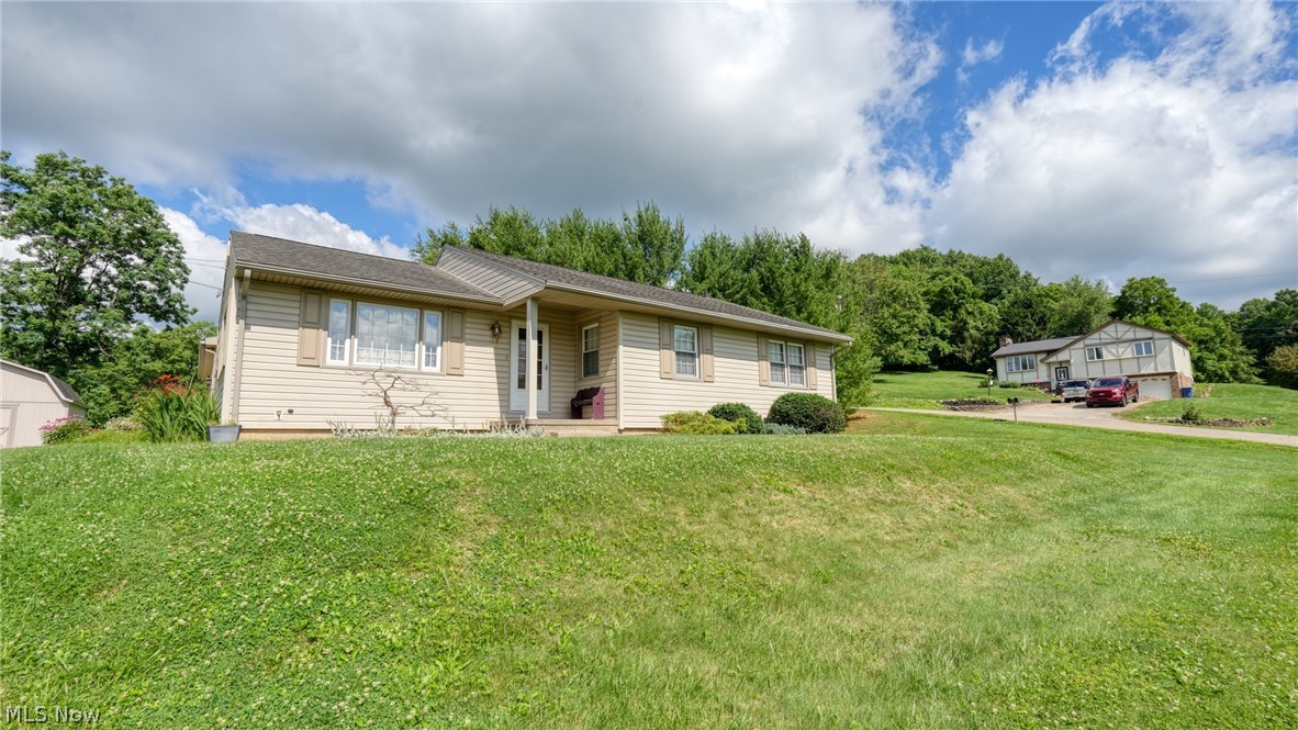 This classic, traditional ranch, has been home for 56 years to the same family.  It has been lovingly maintained and cared for, and is ready for a new family to start making their own memories here.  This home offers a peaceful setting, a private patio, a lovely landscaped yard, and the single level convenience that you will appreciate.  The  all season room is drenched with great sunlight,and is so warm and inviting.   The kitchen cabinets were all updated in the past few years and are in great condition and offers many pull out drawers  in the pantry and cabinets with so much storage space! The living room is a spacious place to entertain, and adding to the convenience of one floor living, is a very nice laundry room with cabinets and space to fold the laundry.  An oversized 2 car garage, and a large storage barn add to the list of many nice features that come with this lovely home.  
This home is well priced and will sell quickly!  Call today for your private showing or contact your Agent ASAP.  Sellers say that it is their understanding that  there is hardwood floors under the carpet in the main living area and bedrooms.