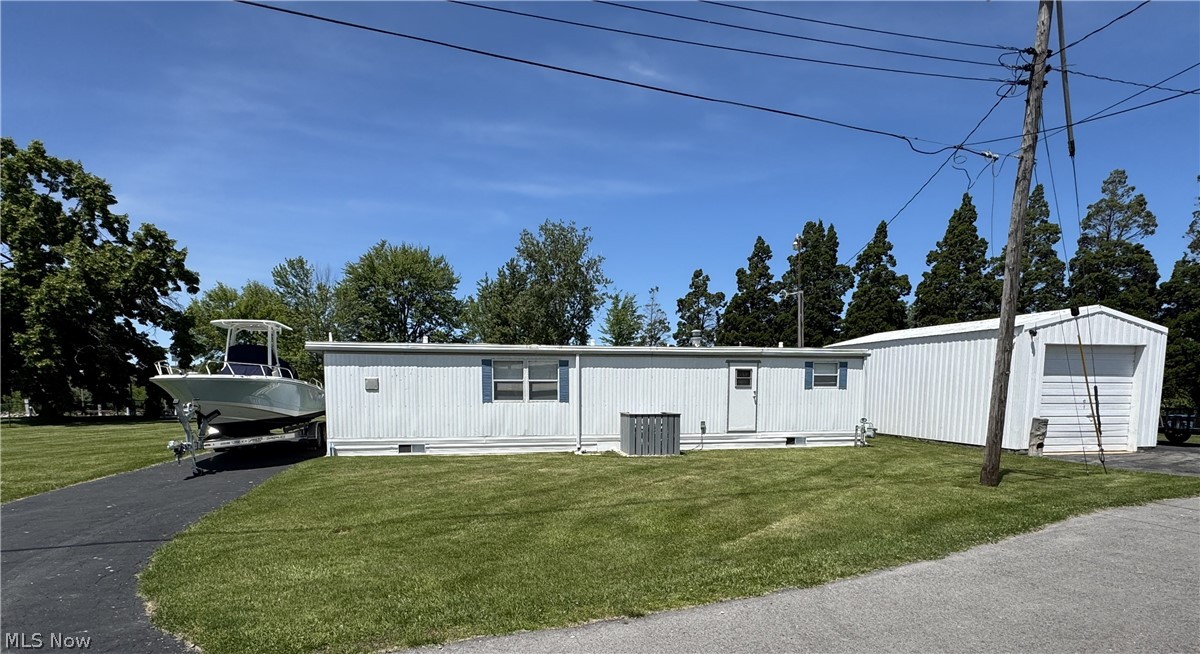 WATERFRONT Property with 85 Ft. private dock in the highly sought after waterfront community of Nugent's Canal. This beautiful, impeccably maintained property is truly a rare find that spans over four parcels located at the end of the street and close to the canal entrance from the Portage River. The parcels include a fully furnished (less personal items), one-bedroom mobile home (that can be converted back to a two bedroom), one-bath that has been updated and is move-in ready. Updates include but not limited to: new windows, new bathroom, new kitchen countertops, sink, floor and refurbished cabinets. Entering from the driveway through the fully enclosed glass-door waterfront sunroom, you are greeted with an expansive living space that can be opened to welcome fresh breezes while enjoying the scenery of boats passing by. A couple more steps into this versatile home, you are greeted with an open kitchen and living space with easy access to the bathroom and bedroom. For all the toys, there is a 14.5 x 31 ft. private garage, and a full vacant lot creating a wonderful yard space. With approximately 85 ft. of dockage out the back door and 225 ft. of surrounding canal water frontage, a relaxing entertaining environment awaits.

Boating enthusiasts will enjoy direct Lake Erie access via canal to the Portage River leading through the historic downtown Port Clinton harbor, making this property an ideal recreational home-base for boating, fishing, and water sports.

Nugent's Canal is known for its lively boating and social culture with the Nugent's Canal Yacht Club and Lagoon Saloon a short golf cart ride away. The property offers a furnished layout suitable for a year-round permanent residence, weekend getaways, seasonal use, or an amazing canvas for your future dream home. Whether you enjoy as-is or wish to update to fit your vision, this property has immense potential. Don't miss your chance to own a beautiful waterfront paradise, so schedule your showing today!