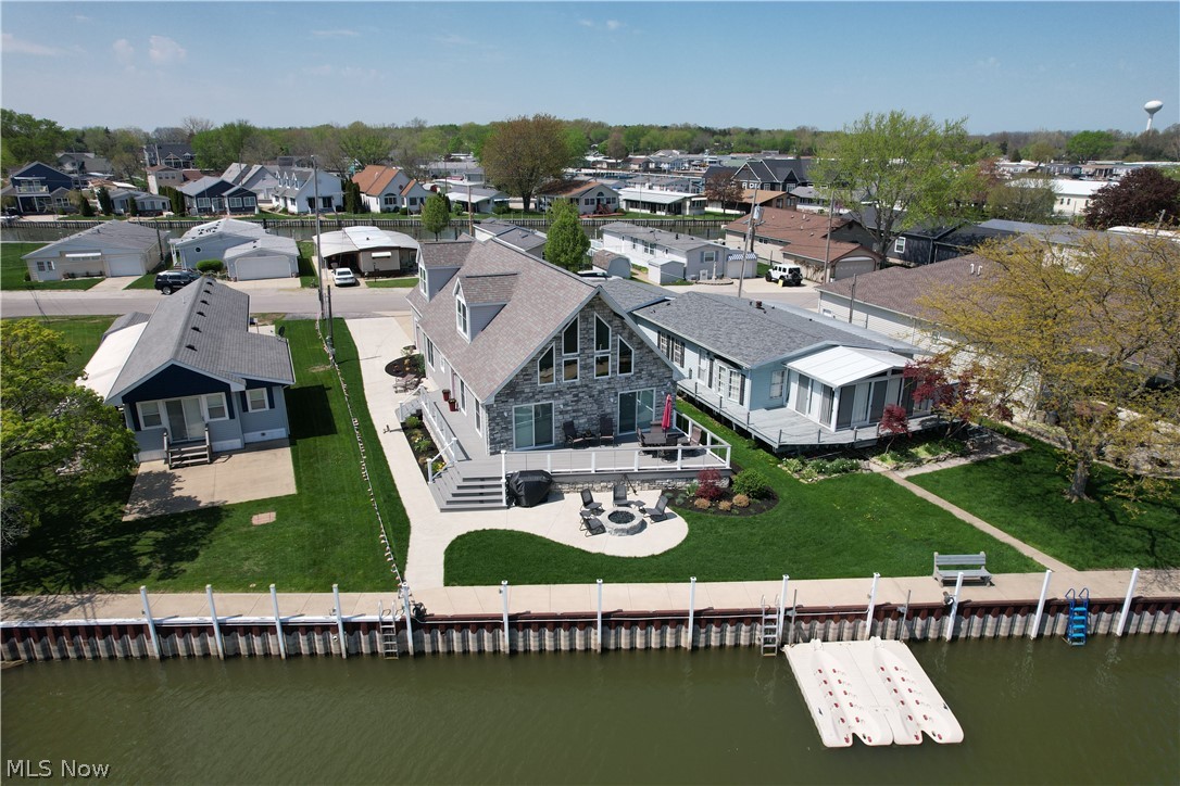 Welcome to this beautiful waterfront home on Catawba Island, where comfort, flexibility, and scenic views come together.

Natural light fills the open-concept living area, highlighted by a cozy gas fireplace and an inviting layout that's ideal for gathering and everyday living. Double patio doors lead to a spacious deck overlooking 52 feet of dock space, perfect for docking a boat or enjoying time by the water.

The main level includes two bedrooms, one of which features an en-suite full bath and a walk-in closet. Upstairs, a generous 32 x 15 space provides versatile options for a variety of needs, whether used as a recreation area, workspace, fitness room, or additional living space, with tranquil canal views. This level also includes a large bedroom, a walk-in closet, and a full bath.

An attached two-car garage (23 x 23) offers added flexibility and features large-screen panels that allow fresh air and natural light to flow through when the doors are open. Recent updates include freshly painted walls, doors, deck, and siding, along with new carpeting and a brand new kitchen.

This waterfront property offers a blend of indoor comfort and outdoor enjoyment. Schedule your private showing to experience it firsthand.