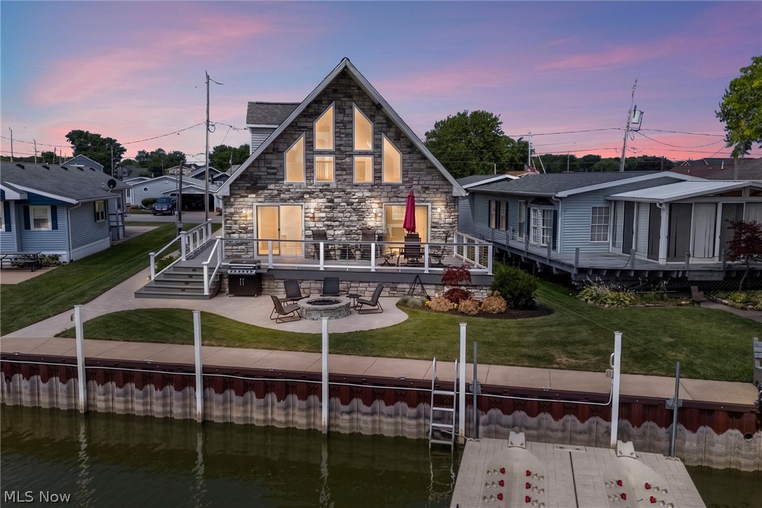 Welcome to this beautiful waterfront home on Catawba Island, where comfort, flexibility, and scenic views come together.

Natural light fills the open-concept living area, highlighted by a cozy gas fireplace and an inviting layout that's ideal for gathering and everyday living. Double patio doors lead to a spacious deck overlooking 52 feet of dock space, perfect for docking a boat or enjoying time by the water.

The main level includes two bedrooms, one of which features an en-suite full bath and a walk-in closet. Upstairs, a generous 32 x 15 space provides versatile options for a variety of needs, whether used as a recreation area, workspace, fitness room, or additional living space, with tranquil canal views. This level also includes a large bedroom, a walk-in closet, and a full bath.

An attached two-car garage (23 x 23) offers added flexibility and features large-screen panels that allow fresh air and natural light to flow through when the doors are open. Recent updates include freshly painted walls, doors, deck, and siding, along with new carpeting and a brand new kitchen.

This waterfront property offers a blend of indoor comfort and outdoor enjoyment. Schedule your private showing to experience it firsthand.