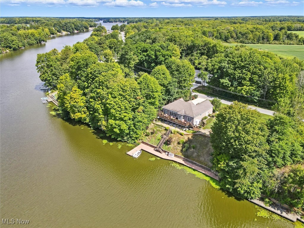 Don’t miss this stunning Roaming Shores lakefront home featuring 160 feet of prime frontage on beautiful Lake Roaming Rock!
Located just inside the “No Wake” zone, this property sits on one of Ohio’s best bass fishing lakes. Conveniently situated just off State Route 11, you’ll enjoy quick access to Cleveland, Erie, Warren–Youngstown, and Pittsburgh.

This move-in ready home comes fully furnished—yes, most everything stays! Just bring the keys and start living the lake life. The photos truly tell the story of this well-maintained waterfront retreat.

Inside, you’ll find four bedrooms with a possible fifth, three full bathrooms (two on the main level, one in the finished walk-out basement), and two complete kitchens—perfect for entertaining or hosting extended family. Enjoy two dining areas, two family rooms, and two cozy gas fireplaces—one on each level.

Step out onto the expansive deck to savor your morning coffee while watching eagles soar and fish along the shoreline. The Jet Ski lift, riding lawn mower, and lake pump for lawn and plant watering all stay with the home.

Roaming Shores offers full-time police protection and a wonderful community atmosphere. Lake Roaming Rock is ideal for fishing, boating, jet skiing, kayaking, swimming, and so much more.

This home is perfect for year-round living or a spectacular weekend getaway—just move in and start making lake memories!