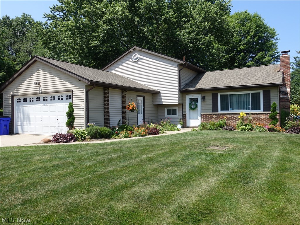 Super nice and updated 3 level split!  The living room is vaulted, has a contemporary flair and offers a wood burner.  The stylish, updated kitchen offers granite counters and custom maple cabinets with spice cabinet.  All lower cabinets are sliders. LG fridge and custom dishwasher. Cork floors in kitchen and Pella kitchen slider.   Three bedrooms with nice closet space and updated full bath complete the second floor.  The family room is a great size and there's a convenient updated powder room.  The laundry area has enough space for a large office.  The slider off kitchen leads you to an awesome patio and nice, flat backyard.  Nice 2 car garage with extra storage.   Updates include: Custom kitchen including appliances - 4 years;   Roof, Patio & extra 3rd driveway (for your RV/Camper or extra vehicle) - 5 years;  Windows - 6 years; AC, heat pump & hot water tank - 7 years.  Nothing to do but move in and enjoy!  Home Warranty is offered to the buyer for peace of mind.