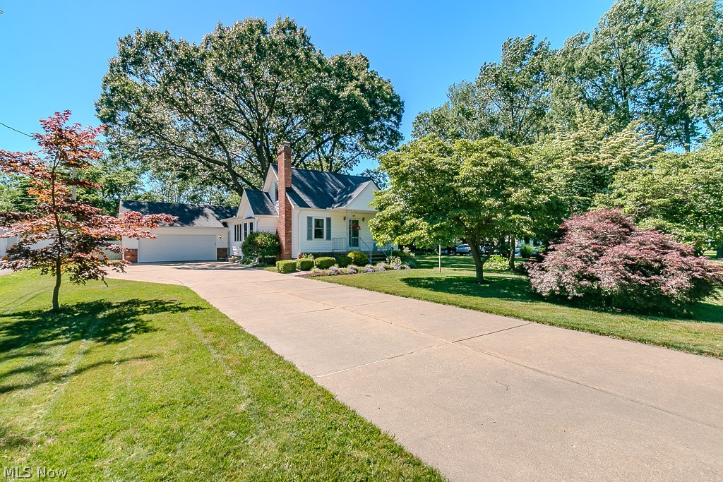 Welcome home to this well-maintained Cape Cod situated on a beautifully landscaped .45-acre lot filled with wonderful gardens, vibrant flowers, and mature landscaping. Offering over 2,850 sqft of finished living space, this 4-bedroom, 2.5-bath home combines charm, functionality, and incredible hobby space. The main level features a spacious living room with fireplace, dining room, kitchen, and two bedrooms, while the second floor offers two additional bedrooms and a half bath. Enjoy complete relaxation in the attached sunroom with nature stone flooring overlooking the backyard oasis complete with deck, gazebo, patio, and tranquil water feature.

The finished lower level adds additional living space with a rec room featuring an oak wet bar with refrigerator, full bath, laundry area, sauna, and utility room—perfect for entertaining or unwinding. Car enthusiasts and hobbyists will appreciate the exceptional detached 3-car garage/outbuilding complete with an automotive lift and attached workshop, offering endless possibilities for storage, projects, or vehicle enthusiasts. A 2-car attached garage provides added convenience. This lovingly cared-for property is truly one of a kind!