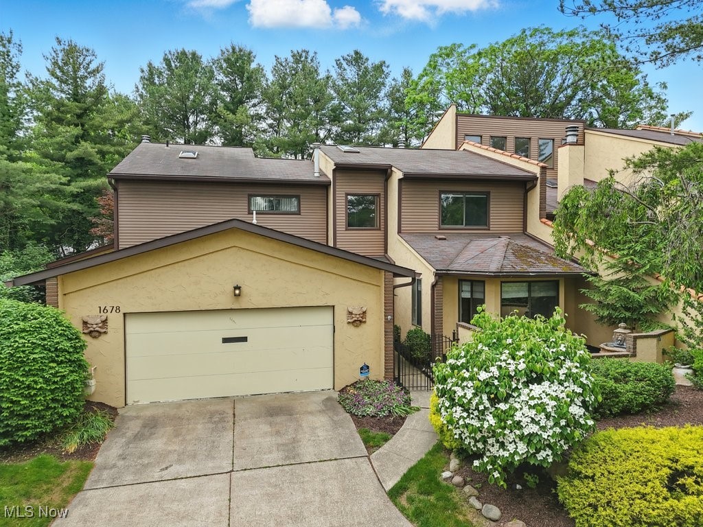 Welcome to this expansive 4-bedroom, 3.5-bath condo nestled in desirable Brookwood Village in West Akron. With 3,800 square feet of beautifully designed living space, this home offers a flexible layout and unlimited potential. It is perfect for those looking to customize and create their dream retreat. With room to live and entertain in style.

Step through the marble-floored entryway into a spacious layout featuring a first-floor master suite with a walk-in closet and private bath. The eat-in kitchen flows seamlessly into the cozy family room, complete with a fireplace and wet bar, and opens to a private deck—perfect for entertaining or relaxing outdoors.

The great room is a true showstopper, with soaring ceilings and a dramatic floor-to-ceiling fireplace that anchors the space. Upstairs, you'll find three generously sized bedrooms—two with private en-suite baths—plus a loft area with custom built-in bookcases, ideal for a home office or reading nook.

Additional highlights include brand-new carpeting in the great room, first-floor laundry, and an attached two-car garage. This rare West Akron gem combines low-maintenance condo living with the space and feel of a single-family home