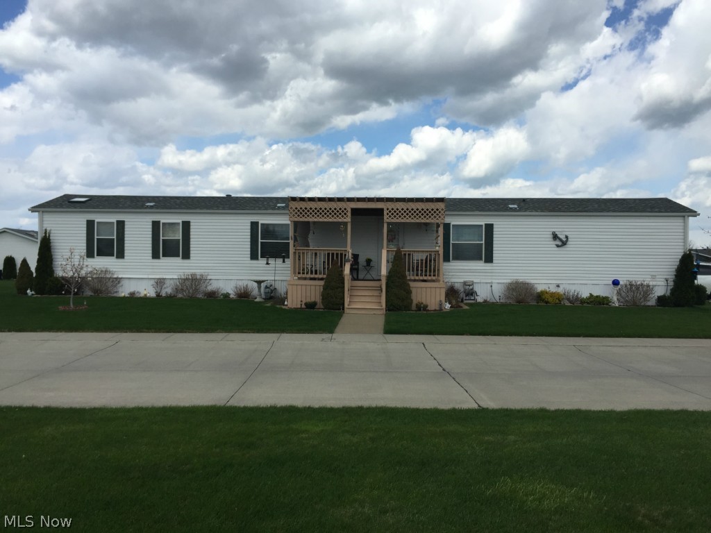 Wonderful summer getaway for an outdoors oriented Owner, or year round living for those who want to be close to Lake Erie! Nicely updated manufactured home on beautiful lot in desirable Bass Haven South, off Church Road in Marblehead. A fisherman's delight!  Home features vinyl siding, spacious covered front porch, updated A/C in 2012, new roof in 2012, HUGE Florida room, utility/tackle room, carport with parking for two cars, & concrete driveway with parking for two more cars. Bring your boat and be ready to bring in the walleye and perch!  Bass Haven South has a nice park area available to residents with picnic shelter, convenient to this home.  Home features a comfortable living room, spacious kitchen, dining area, great second bedroom & bath, also a good sized master bedroom with master bath, which includes separate shower & whirlpool tub. Footprint of home area is all cement with lush grass surrounding and many perrenials with flowering plants & landscaping. Boat storage right nex