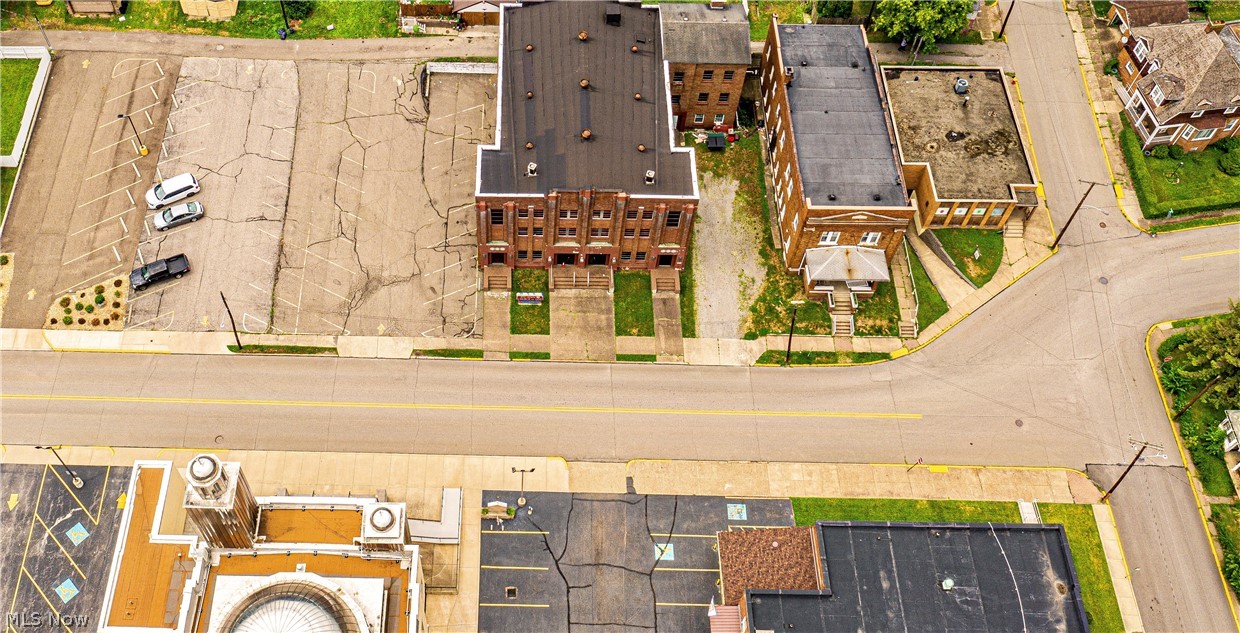 SO MANY POSSIBILITIES! Currently set up as 2 apartments and a fellowship hall with commercial kitchen. Apartment number 1 could be converted back into two apartments making 3 apartments and a hall! Building next door is currently used as a church and has a large parking lot. The Church could also be converted into additional apartments or office space. Rarely do you find a location with ample parking and such a prime location near all highways WV to OH and PA!  The income possibilities are endless! Live in one? Rent out one? Run a business? SO MANY OPTIONS! Call today to schedule a showing and see for yourself all the possibilities these buildings have to offer.