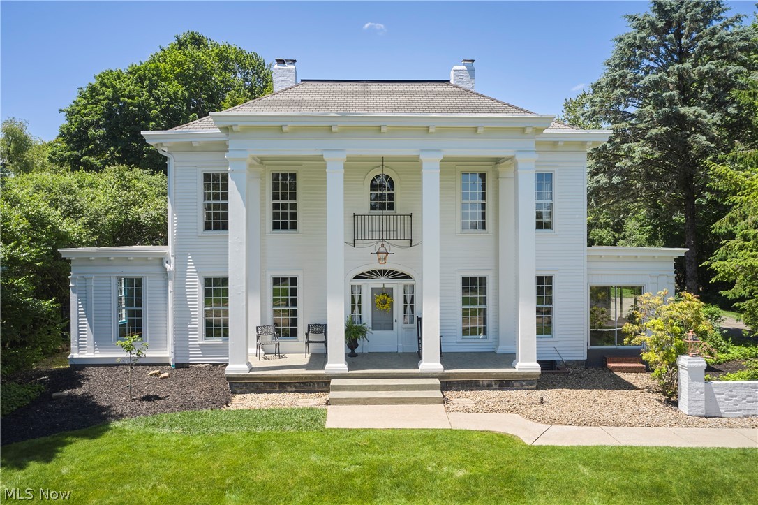 Built circa 1885, the Merriman Farmhouse has been lovingly restored to reflect the Georgian Revival style and timeless elegance of the grand homes of that era. Gleaming Redwood columns rise atop a gentle hill overlooking historic Merriman Road, while the in-ground pool & guesthouse create an exceptional setting for entertaining. A 2-story front porch leads to sweeping foyer thats flanked by a stately dining rm w HW floors & a gas FP w marble surround to the right & a beautiful living rm to the left w HW flrs, gas FP w marble surround & historic windows. The wood-paneled den w FP & handsome built-ins. A charming 3 season rm (formerly a sleeping porch) w 2 sliders w new glass, wood-paneled walls & traditional 'haint blue' ceiling. The kitchen feat. Viking range, new sink & faucet, a lovely dinette w picture window. Mudroom connects the home to garage & feat. new split HVAC, slate tile floor, built-in cabs & original arched windows. Enjoy summer evenings on the screened porch overlooking pool & new patio. A 1st floor laundry rm w quartz c-top, full BA & half BA of of front foyer complete 1st floor. Upstairs 4 well-sized BRs, all w beautiful HW flr, 2 full BA incl. 1 w tile floor, subway tile shower, dbl sinks & linen cab. while the other feat. tub/shwr & pedestal sink. The bsmt feat. 2 brand-new 50-gal HWTs, 2nd laundry, daylight windows, 200-amp panel w newer service cable & 400k BTU steam boiler. The backyard is a hidden oasis w a 20x40 in-ground chlorine pool w new cover, heater '23, filter & pump '23, 3 sheds. A new brick patio, pavilion w chandelier & Redwood deck creates the perfect backdrop for summer fun. The 1 BR 1 BA 1250 sqft Redwood-sided guesthouse w Pella windows, parquet flr, vaulted ceil. w skylights, kitchen w charming cabs & newer s/s appl., updated full bath, own HVAC. Main home painted w SW Emerald paint '24. The Merriman Farmhouse is rich with history, original character, thoughtful updates & exceptional spaces for entertaining & overnight guests.