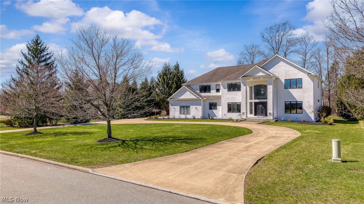 Beautifully remodeled contemporary Colonial in Pepper Pike’s desirable L’Avion community on a private 1.03-acre lot. This 4-bedroom, 4.5-bath home offers 4,508 square feet of light-filled living space with soaring ceilings, an open floor plan, and grand-sized rooms. The dramatic great room with a two-story fireplace opens to a designer kitchen with a massive island, white cabinetry, waterfall quartz countertops, and walls of windows. First-floor office with adjacent full bath offers flexible guest or bedroom space. Luxurious primary suite with sitting/workout area, large walk-in closet, and spa-like bath. Features include hardwood floors, two fireplaces, wired speaker system, Ecobee multi-zone remote climate control, video doorbell system, 3-car attached garage, circular drive, outdoor hot tub, updated exterior, and full basement ready to finish. Prime location near I-271, shopping, dining, and parks.