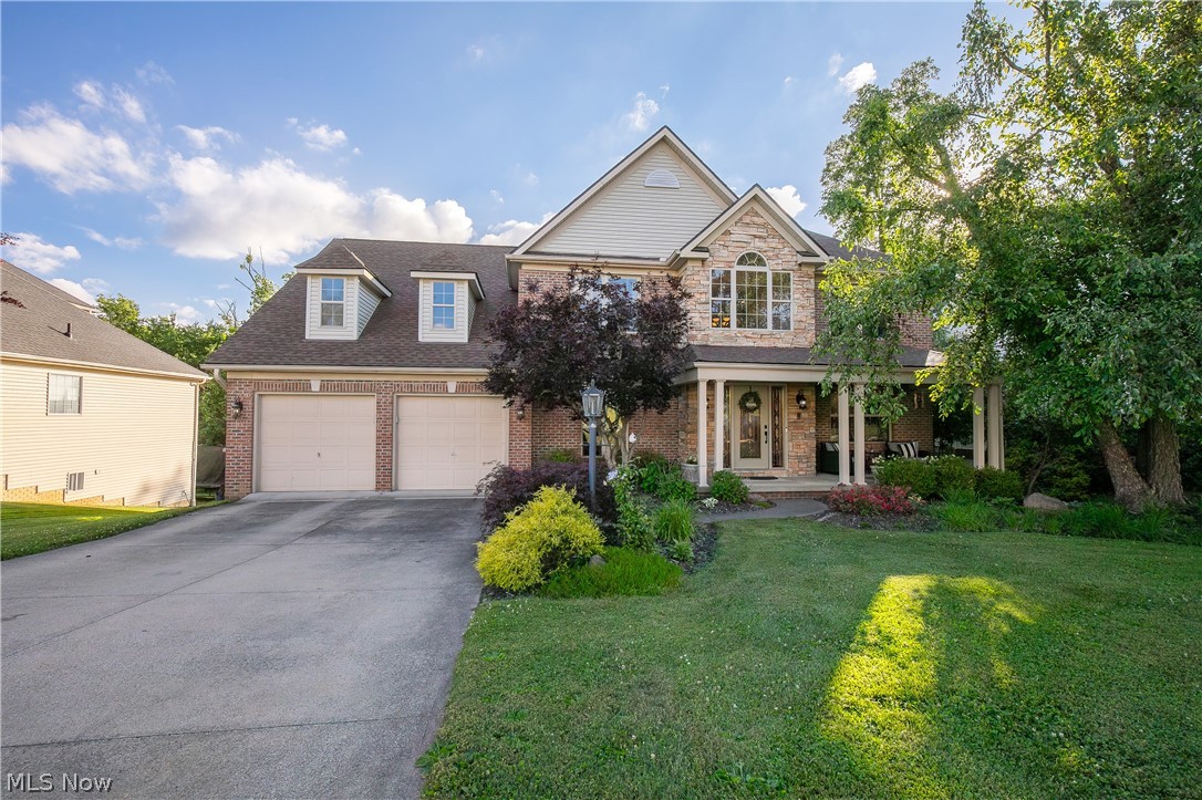 Nestled on a wooded homesite in desirable Copley, this spacious and meticulously maintained home offers the perfect blend of privacy, comfort, and functionality. Timeless curb appeal welcomes you with a covered front porch, beautiful brickwork, and mature landscaping.

Step inside to an impressive two-story foyer filled with natural light. The thoughtfully designed floor plan features a formal dining room, sitting room overlooking the front porch, and spacious living areas ideal for everyday living and entertaining.

At the heart of the home, the oversized kitchen features granite countertops, abundant cabinetry, and generous workspace. A wet bar connects the kitchen and dining room, while the butler's pantry with a secondary refrigerator provides exceptional storage and serving space.

The great room is the centerpiece of the home, showcasing floor-to-ceiling windows overlooking the backyard and a fireplace that creates a warm, inviting atmosphere year-round.

Outside, enjoy a large deck overlooking mature trees, a level yard, and a fire pit area perfect for relaxing or entertaining. The private setting offers the tranquility buyers are searching for.

Generously sized bedrooms and thoughtful features can be found throughout. The primary suite serves as a private retreat with a fireplace, oversized layout, dual walk-in closets, and a spa-inspired bath featuring a soaking tub and tiled shower.

The expansive lower level offers impressive ceiling height and endless potential for additional living space, recreation, fitness, or entertainment.

Combining exceptional living spaces, a private setting, and endless possibilities, this home offers luxury living in one of Copley's most sought-after locations.
