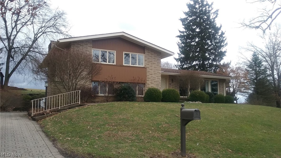 This split level family home has almost 2400 sq ft. Lower level with 1978 sq ft of finished living areal.  Upper level has a large Master Suite with updated bath and access to rear balcony.  There are 2 additional bdrms with an additional updated,  full bath.  Main Floor has a large living room and dining room.  The eat in kitchen has tons of cabinets and counter space with updated countertops, backsplash and stainless steel appliances.  From the kitchen or dining room go out to the lovely sun room to the rear of the home which opens to a large outdoor patio and great backyard.  Downstairs there is a very cozy but spacious family room with gas fireplace.  The laundry and a 1/2 bath are on this level.  The paved drive leads into the 2 car attached garage.  From the garage there is access into a large storage room with tons of shelving and this area also houses the utilities. Utilities of electric and village water/sewer are very reasonable for a house this large.  There are 3 separate h
