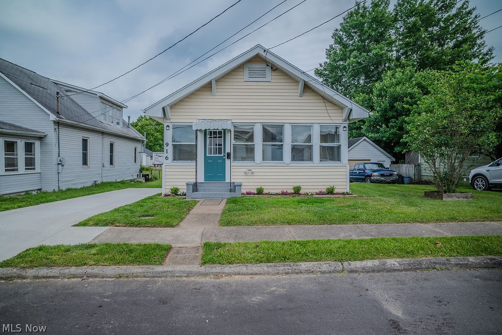 Some homes have updates. Some homes have character. This one offers both.

Original woodwork, 9 foot ceilings, and a sunroom lined with windows that fill the space with natural light set the tone for this thoughtfully updated home filled with charm and the convenience of one floor living.

Start your morning in the enclosed sunroom before stepping into the living room, where rich natural wood trim, original windows, and a decorative fireplace with a gas hookup create a warm focal point. The living room flows into the dining room, where built in window seating offers hidden storage and a cozy spot for a favorite book or morning coffee.

Two bedrooms and a beautifully remodeled full bath are tucked just beyond the main living spaces. New carpet with upgraded 8 lb padding and moisture barrier, updated flooring, and refreshed finishes throughout allow you to move right in and start enjoying the home.

The kitchen blends functionality and style with oak cabinetry, updated brushed gold hardware, new countertops, new dishwasher, and new flooring. Downstairs, the freshly painted and dry locked basement provides generous storage space, including additional storage beneath the enclosed porch.

Outside, the level lot offers space for both everyday living and entertaining. A covered rear porch overlooks a versatile paved area that can serve as additional parking or an outdoor gathering space, with easy access to the gravel alley parking area. A storage building provides even more room for tools and seasonal items.

Major improvements include a new roof, vinyl replacement windows, new plumbing drains, updated flooring, new carpet, and a newly paved driveway, adding peace of mind while preserving the home's original character.

Character, storage, updates, and one floor living all come together in a home that's ready for its next chapter.