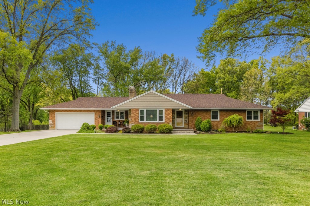 Look no further than this gorgeous brick ranch situated on three spacious lots—perfect to enjoy as extra yard space or potentially sell off to a friend or family member. This beautifully remodeled home offers four bedrooms, all on the first floor, with every inch thoughtfully updated. The gourmet kitchen features ample cabinetry, generous countertop space, a large bar/island with seating, and a walk-in pantry.

The home flows effortlessly from the roomy breezeway/foyer—offering multiple layout options—into the open kitchen, dinette, and sitting room or formal dining room with a cozy fireplace. From there, the floor plan leads into the family room and continues to the bedroom wing, which can be configured as four bedrooms or three bedrooms plus an office or main-level laundry.

Hardwood floors run throughout, and the updates make the home feel nearly new. The partially finished lower level adds even more usable space. Outside, enjoy a maintenance-free exterior, a large deck and patio, and an outdoor fireplace—ideal for relaxing or entertaining. A four-car garage completes the package.
This home truly has it all.

Updates from 2016:
New everything basically inside and out including heating, cooling, water tank, electric, Kraftmaid cabinetry, Baird Brothers hickory hardwood flooring throughout— outside drains, gutters, soffit, deck (composite), garage doors 
Whole roof done in 2015–then 3/4 if it redone in 2024 due to tree branch falling
Driveway 2021