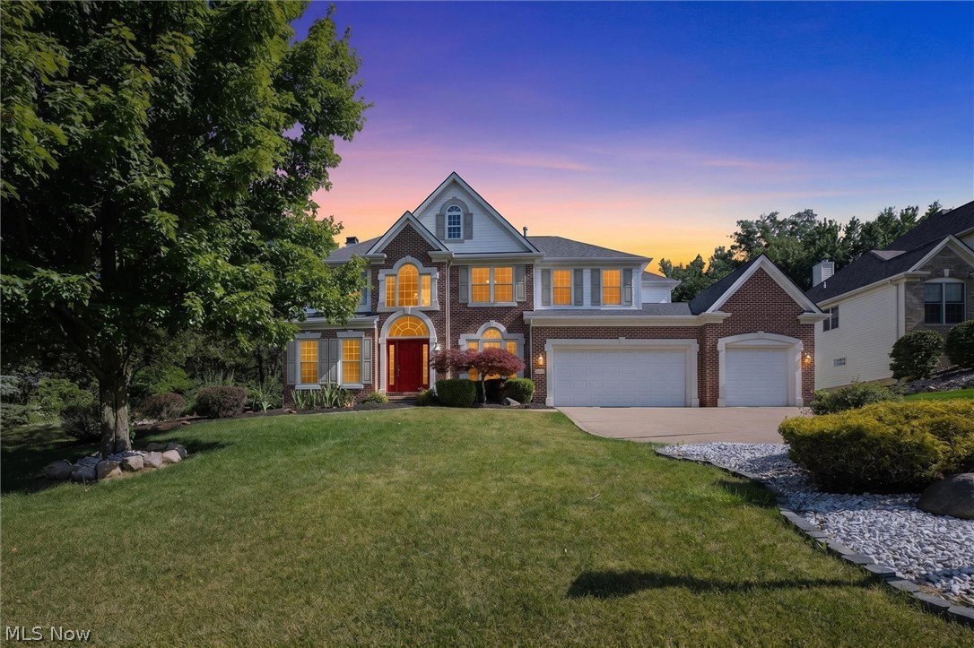 There's built, and there's Parkview-built. This home is the latter, crafted by the local family name behind West Hampton, and it shows.
Move through the home and it opens to a moment you do not forget. A two-story great room wrapped in arched windows, light spilling across hardwood, a fireplace at its heart, and a wall of glass framing the wooded backyard beyond. This is the room the home is built around, and the kind of space you cannot add later.
It flows open into a kitchen that earns its place beside it: warm wood cabinetry, granite counters, stainless appliances, a center island, and a walk-in pantry, with a breakfast area that overlooks the rear yard. A two-story foyer, a formal sitting room, and a dining room framed by an arched window and fine wainscoting round out the main level, along with a rare bedroom in this footprint, full bath, and laundry. The spacious three-car garage adds an outlet ready to charge an electric vehicle.
Upstairs, the owner's suite anchors the end of the hall with an oversized walk-in closet, joined by three more bedrooms and a loft that overlooks the great room below.
The walk-out lower level is the difference maker. Fully finished in a mix of plush carpet and brand-new luxury vinyl plank, it offers open living, a full bath, a bonus room, and a second kitchen, a true in-law and guest suite with its own walk-out entrance.
Outdoor living comes on two levels: a covered composite deck off the kitchen, built for dining in any weather, and a stamped-concrete patio off the walk-out below. Beyond, a fully fenced yard backs to mature woods. Private, green, and quiet. Your pets will love it! 
Meticulously maintained, with a new 2025 roof, plus furnace, air conditioning, and hot water tank updated in 2018. The big things are done.
All in the award-winning North Royalton City School District, minutes from shopping, dining, and major routes.
The home that sets the standard on West Hampton. Schedule a private tour today.