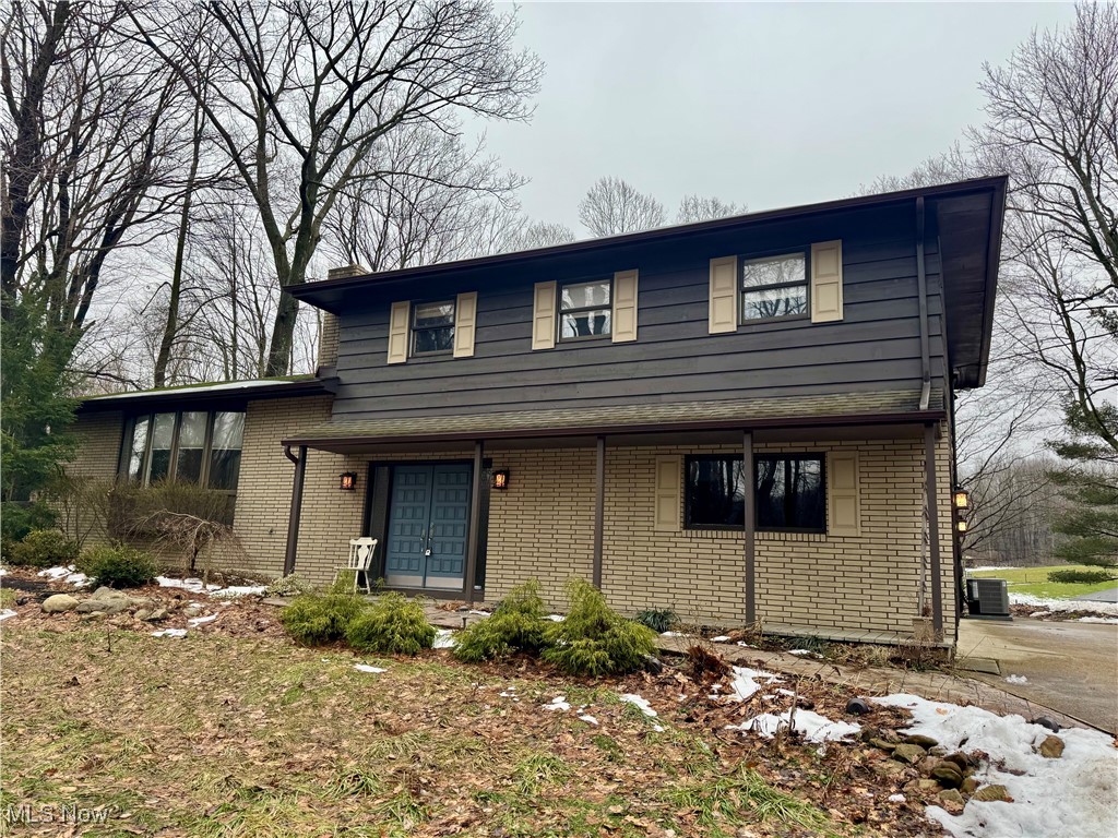 Here is your chance... this uniquely designed home includes multiple acreage and privacy that you have been dreaming of.  A private retreat as you enter the roughly 500 ft winding driveway to this exclusive oasis.  This home provides you an opportunity to own something different and exclusive. As you approach the covered front porch and enter through the double doors you will be greeted by a grand, winding staircase and spacious foyer. The vaulted ceiling living room enjoys a word burning fireplace adorned with stone.  The updated kitchen provides a functional layout which has updated shaker cabinets, granite counters, and new tile flooring. The primary bedroom is spacious, has amazing private views and enjoys a balcony with a sliding glass door.  The primary bathroom has been totally revamped as well as the second full bath.  Many doors have been replaced throughout except the front door and primary bedroom slider.