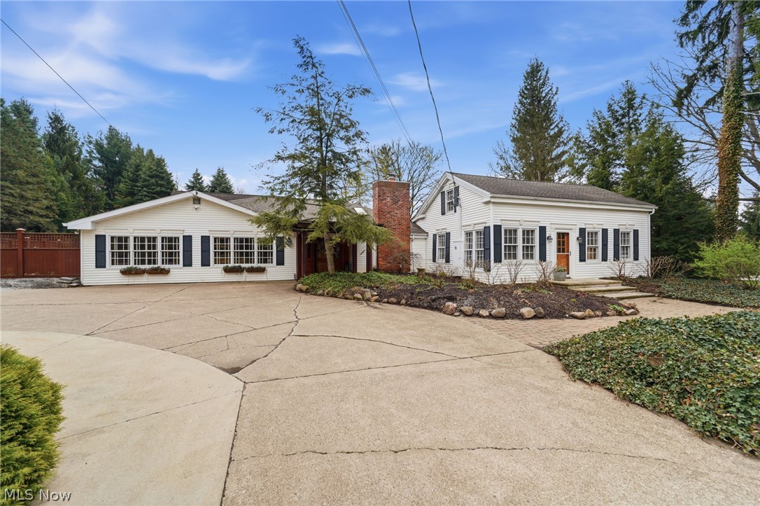 An extraordinary, one-of-a-kind estate where timeless character meets elevated luxury living. The beautifully remodeled century home, thoughtfully expanded, offers 5 bdrms and 4 full baths, blending historic charm with modern sophistication. The front entry opens to a beamed dining room with a floor-to-ceiling stone fireplace. The inviting great room features a stunning stone hearth w/wood-burning fireplace, while the sunlit morning room—with sliders to the outdoor entertaining spaces—creates seamless indoor-outdoor living. At the heart of the home is a true gourmet kitchen designed for everyday living and entertaining, complete with a large breakfast bar, Quartz countertops, and premium appliances including a Sub-Zero refrigerator/freezer, wine cooler, Bosch dishwasher, double ovens w/warming drawer, and a 6-burner Wolf cooktop. The main level continues with an expansive family room with custom built-ins, an office flowing into a game room, additional bdrms, and a spectacular screened-in porch with kitchenette. The second-level primary suite has its own private staircase and features an ensuite bath, custom closets, and a dedicated dressing area. Throughout, exquisite craftsmanship shines with rich woodwork, solid wood doors, and maple and hickory flooring. NEW ROOF 6/2026. The second structure—zoned for office use—offers its own driveway, kitchen, full bath, and flexible living spaces, ideal for a home business or guest quarters, also a NEW ROOF 6/2026. The impressive 3,400+ sq ft “Party Barn” is an entertainer’s dream with a large open area, full kitchen, dining space, full bath, and loft with two additional rooms. Additional outbuildings include a charming former sugar house and multiple storage structures. Outdoor amenities rival a private resort, featuring a pool house w/full bath, steam shower, and changing rooms adjacent to the in-ground pool w/surround patio area. A property standby generator and lush landscaping complete this exceptional private oasis.