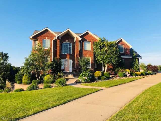 Magnificent brick home tucked back on a cul-de-sac with stunning curb appeal and tree lined property in a desirable subdivision just outside city limits. Luxury and coziness combined in this 4 bedroom 4.5 bath home. Custom wood trim and solid wood doors.  A spacious living room with warming brick wall fireplace has a setback for your media center. French doors to a beautiful picturesque patio. Formal dining room with bayed window and a 1st floor home office.  A chefs kitchen is ready for cooking and entertaining with a spacious granite topped island, lots of counter area with stunning granite, beautiful cabinetry, stainless appliances, and exceptional views of the property while you are preparing meals. First floor laundry,  half bath and a beautiful open foyer complete your main level of living space. The upper level has your owner suite with a well lit bedroom,  large bath and walk in closet that has lots of hanging and shelving space. 2 additional bedrooms each have their own full b