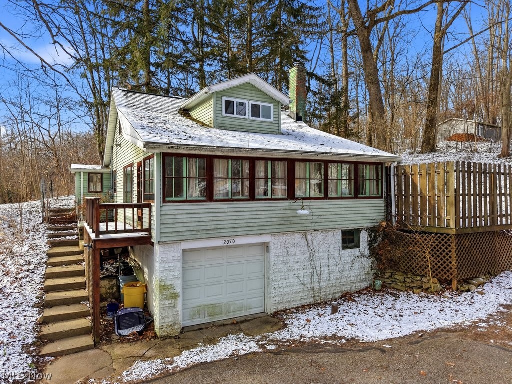 Charming Cape Cod offering over 1,200 sq. ft. of living space, ideally situated across from scenic Brady Lake and set on an impressive six parcels. This 2-bedroom, 1-bath home combines character and functionality. A welcoming mudroom with built-in storage provides a practical entry point into the home. Inside, the living room features an open, airy feel with abundant windows that fill the space with natural light, along with a built-in corner hutch that adds to the home’s charm. The updated kitchen showcases dark cabinetry, ample counter space, and generous storage, making it both stylish and functional. Both bedrooms feature hardwood flooring, adding warmth and character throughout. Outside enjoy the side deck with partial fencing, offering a sense of privacy and a great space to relax or entertain. With its unique setting near the lake and multiple parcels providing added space and potential, this property presents a wonderful opportunity just in time for summer.