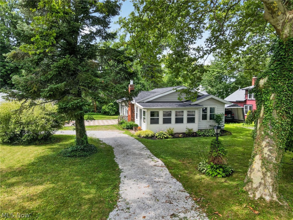 Welcome to this one-of-a-kind Designer-Inspired Ranch situated in one of Madison`s most desirable neighborhoods, on a beautiful tree lined street, ideally located just minutes from the shores of Lake Erie.
Designer finishes meet effortless one-floor living in this completely refreshed Madison ranch. Every detail has been thoughtfully curated blending timeless charm with modern design. The stunning kitchen is the heart of the home, featuring rich forest green cabinetry, warm butcher block countertops, custom floating shelves, stainless steel appliances, and a charming built-in coffee bar. Dining room is located off the kitchen with views of the beautiful new outdoor patio. Light and bright open living spaces are finished in warm, organic tones. You will also find two attractively designed bedrooms with ample closet space, 1.5 bathrooms and a laundry space. The enclosed sunroom adds additional living space to this home, offering a peaceful area to enjoy slow mornings or relaxing evenings. The new patio and backyard space offer a perfect area to entertain or simply unwind and enjoy the great outdoors. NEW ROOF 2026, A/C added & WINDOW REPLACEMENT 2024, ELECTRICAL UPDATED 2023. Conveniently located near beaches, wineries, restaurants, and local parks, this is the perfect opportunity to enjoy the best of Madison living in a move-in-ready home with ease and peace of mind. Whether you’re looking for your first home, downsizing, seeking a short-term rental to add to your portfolio or searching for a weekend retreat near Lake Erie, this beautifully updated ranch is ready to welcome you home.