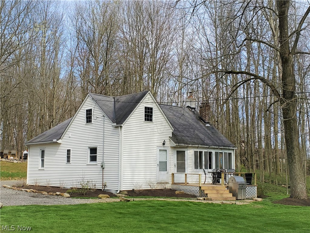 This charming, private, 2-bedroom home with fireplace is nestled in the woods, surrounded by beautiful landscaping, timed lighting, and stone is a must see!  Step outside from enclosed porch onto new deck and enjoy quiet evenings further out into yard on a second deck with firepit and bar, which backs up into 150 acres of protected land!  This home includes a solid, insulated, attic which could be converted into a bonus room. Includes Kinetico® water filtration system and a 1-year home warranty!