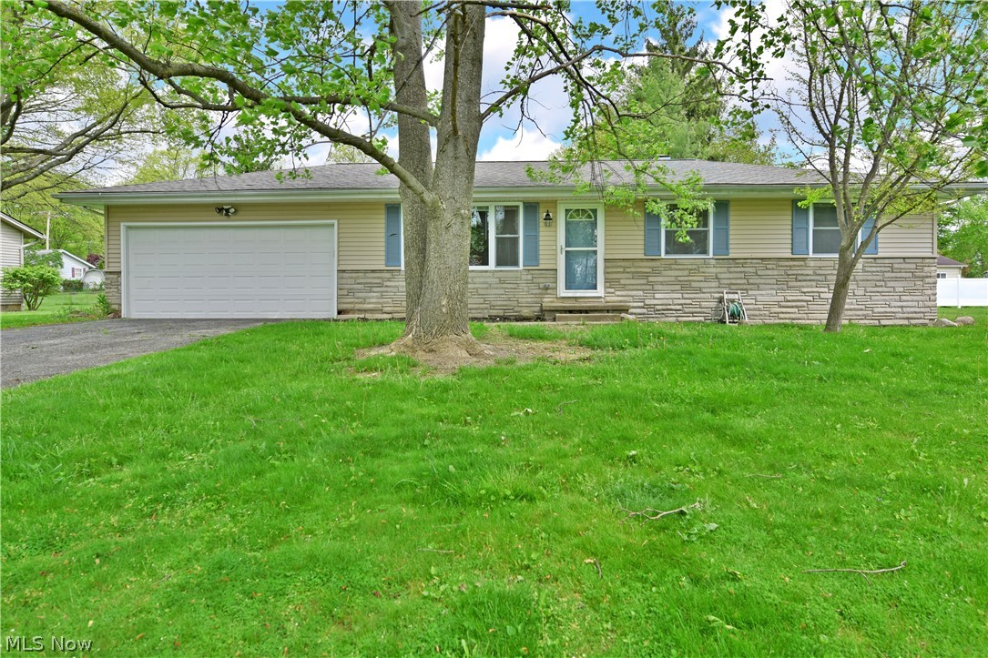 Make this beautiful, move-in-ready ranch your new home! Take advantage of this lovely Howland Township residence and its two floors of finished living space. Hidden away in the shade of tall trees, a charming tan and blue exterior peeks out between the leaves to welcome you inside. Through the front door, lovely cherry colored flooring fills the spacious living room. A huge picture window fills the area with natural light and continues down the main hallway. Nearby, the gracious kitchen reveals an open layout with tons of available space to prepare your favorite meals. The updated kitchen in 2016 offers new cabinets, countertops, flooring, and black stainless steel appliances that are staying. Eat-in style casual dining rests before sliding glass doors that lead to the covered rear cement patio. At the end of the main hallway, a wonderfully updated bath boasts elegant tile work as additional closet space separates the three relaxing bedrooms with great closet space. Downstairs, a deep-