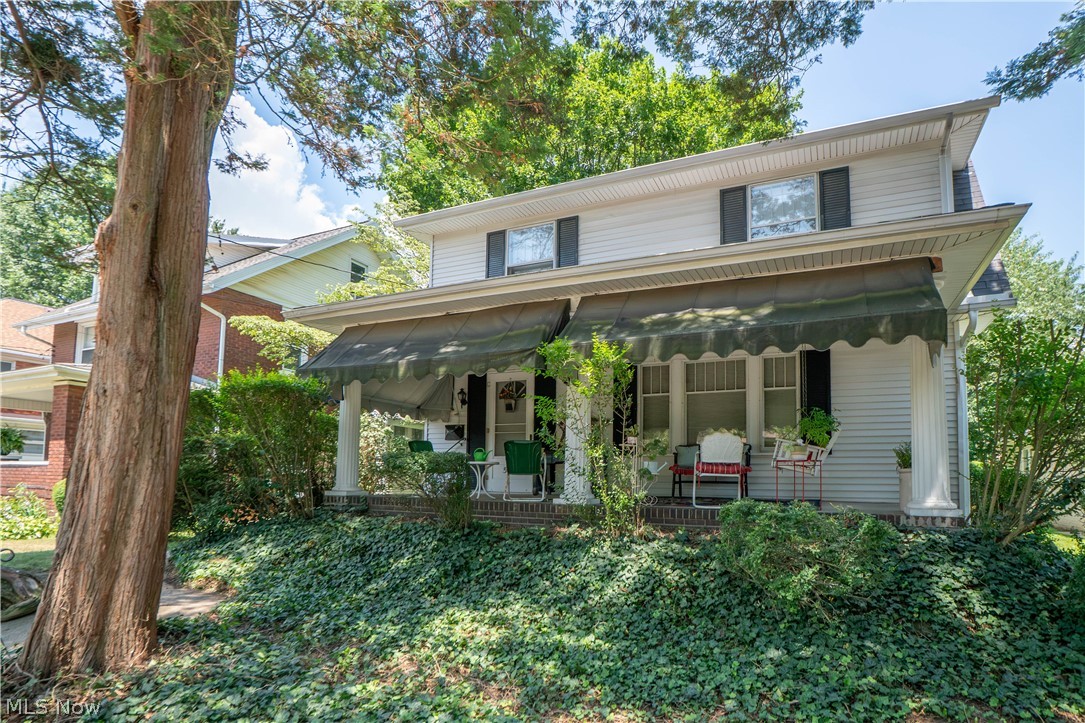 Full of charm and character, this solid North Canton Colonial offers 4 bedrooms, 1.5 baths, hardwood floors, and inviting spaces throughout. A massive covered front porch with classic details sets the tone before entering the spacious living room, where hardwood floors, a fireplace, arched doorways, and warm natural light create a comfortable gathering space. The living room opens up to the the formal dining room through French doors, offering a great layout for everyday living or entertaining. Just off the dining room is a den/flex space, perfect for a home office, reading room, or play area. The eat-in kitchen features appliances, a cooktop on an extended countertop, double wall ovens, and a dining area with windows overlooking the backyard. A half bath, pantry-style hallway shelving, rear access, and basement access add function to the main level. Upstairs are three bedrooms with generous closets, including a primary bedroom with access to a rooftop balcony overlooking the beautiful yard. The full bath features tile flooring, tile half wall, tub/shower combination, additional vanity space with a linen cabinet. The third-floor loft bedroom adds flexible space with built-in storage, a window seat, and a built-in writing desk with shelves. The unfinished lower level provides laundry, washer and dryer, and excellent storage. Outside, enjoy a nice backyard, two side entrances, a driveway located off the back street, and a 2-car detached garage. A charming home with quality details, great space, and a convenient North Canton location!