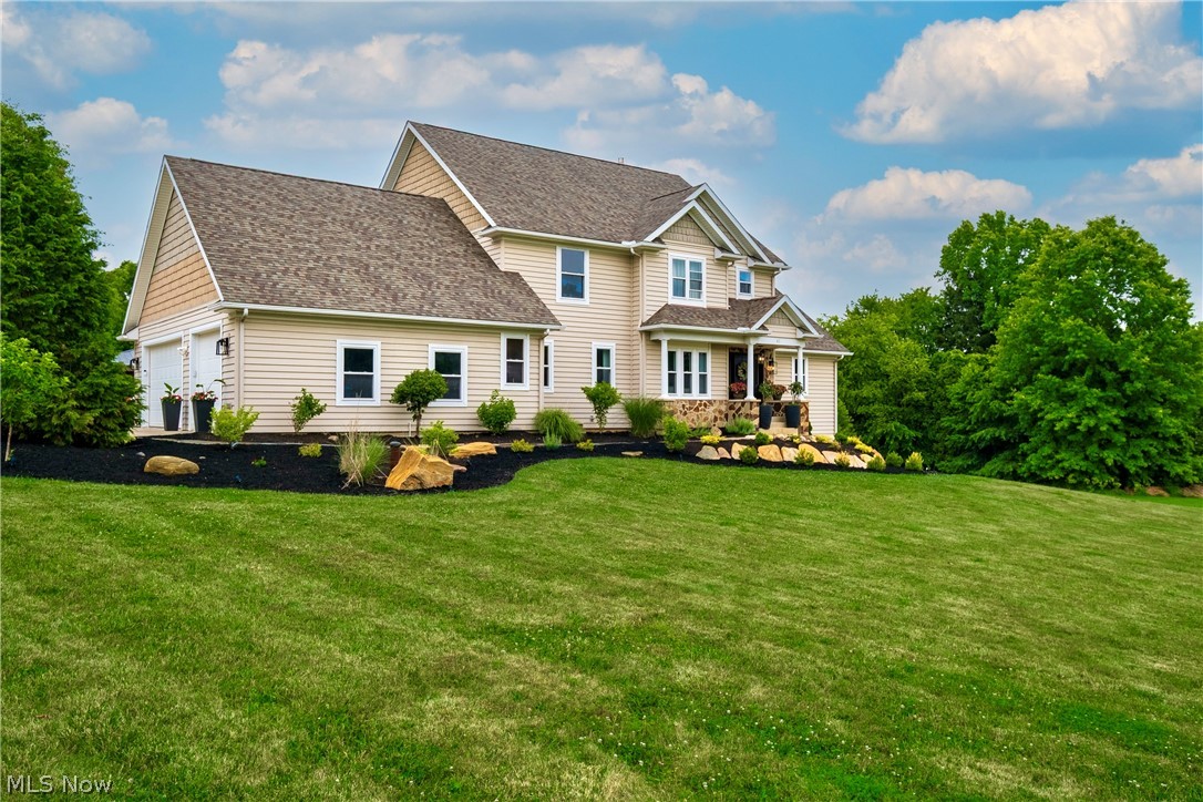 A rare find with nearly 5 acres between Jackson Twp and Akron!  Walk across the street to the beautiful Nimisila Trail Reservoir Park for fishing, kayaking, and more (close to Portage Lakes)!!  This home has a wonderful open floor plan with new wide plank flooring and has been significantly remodeled inside and outside. A grand foyer entry opens to a two story great room with a soaring ceiling, new floor-to-ceiling fireplace design, and updated staircase overlooking the gorgeous wall of windows and views of the lovely acreage (perhaps awaiting your dream garage or pool)?!  Highly sought after first floor master suite with cathedral ceiling, spacious master bath with his and her vanities and extra closet space.  The spectacular and fully applianced kitchen features a tiered center island with granite, a breakfast bar and a dining area with shiplap accent wall, ideal for entertaining and daily living.  A formal dining room is possible...currently used as a cozy and quiet sitting room (this could be a in-home office space). You will love the convenient first floor laundry room - so light and bright with marble accent wall, a half bath and fresh paint throughout...every room has been updated. The second floor features 2 bedrooms with a jack & jill bathroom and a finished loft...ideal for gaming area or play room. There is so much more...bring your ideas for detailing a wonderful partially finished walk-out lower level with natural light, 9' ceilings, a 4th bedroom and plumbing for a bathroom. Built in 2010, features a three-car attached garage (with EV plug only), a rear composite deck with all new railing & facia, all new landscaping & hardscaping with lights, most all fixtures are new -plumbing and lighting... must see!