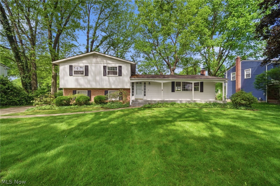 Beautifully updated 3(4) bedroom 2 bathroom home sitting in a wonderful family neighborhood on a park like setting lot. Welcome your guests onto the spacious composite deck front porch and into the open and airy entry. Hardwood floors and an original time appropriate brick planter are a welcome site. The spacious entry with a large closet make welcoming guests special and easy. The light filled living room and dining room connect purposefully leading to new sliding door onto the deck and overlooking the private backyard. The kitchen as been updated and refreshed with newly painted cupboards, quartz counters and stainless steel appliances. The kitchen offers a nicely sized dining area and another direct access to the backyard. An updated 1/2 bathroom is perfectly secluded and convenient finishing off the main floor living. Up a few stairs to the top floor  are 3 nicely sized bedrooms with hardwood floors and an updated full bathroom. Down a few steps to the side load garage, making it very convenient for groceries access and entry during winter and rain. A full basement is off the garage offering laundry and a 4th bedroom or additional family hangout space.  This home offers a lot of flexibility and convenience for living. High efficient furnace and a whole house exhaust fan make this home energy efficient. Don’t miss out on this special