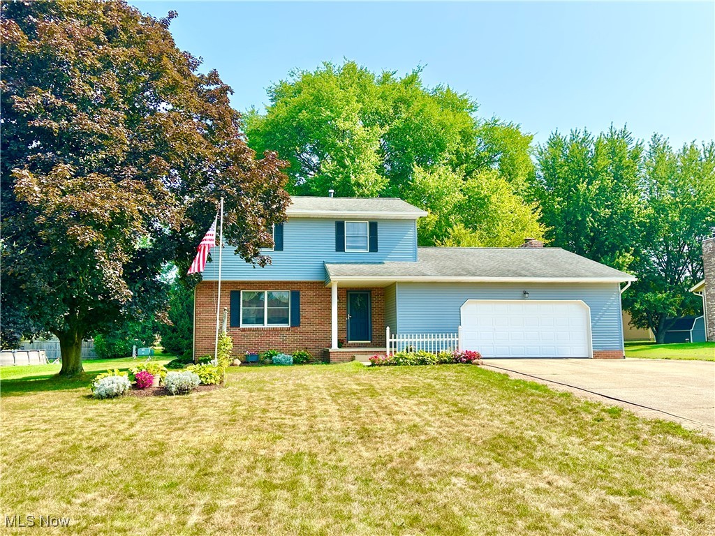Welcome to 1749 Cove St. NW in Uniontown, OH 44685! This charming Colonial home offers three spacious bedrooms and three bathrooms, blending classic elegance with modern comfort. Nestled in a sought-after neighborhood, it features a beautifully landscaped yard and a large deck perfect for entertaining. The interior boasts a stunning floor-to-ceiling brick fireplace, luxurious granite countertops in the kitchen, and gorgeous wood floors, first floor family room plus Recreation Room in the lower level.  The oversized two-car garage adds convenience and ample storage. This is the ultimate blend of style and functionality!