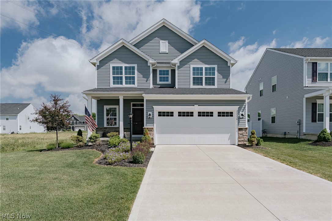 Welcome to 23558 Daisey Drive, a beautifully maintained contemporary colonial that offers the perfect blend of modern style, thoughtful design, and everyday comfort. Built just a few years ago, this move-in-ready home is ideal for today's busy family, featuring an open-concept layout filled with natural light and inviting living spaces throughout. Step inside the welcoming foyer, where durable LVP flooring flows seamlessly throughout the main living areas. The spacious living room serves as the heart of the home, highlighted by abundant natural light and an elegant fireplace that creates a warm and cozy atmosphere for gathering with family and friends. The well-appointed kitchen is sure to impress with quartz countertops, a stylish tile backsplash, stainless steel appliances, and a large center island with breakfast bar seating. Open to the dining area, this space is perfect for everyday meals and entertaining alike, with sliding door access leading directly to the backyard. A beautifully finished half bath featuring a dramatic floor-to-ceiling tile accent wall completes the first floor. Upstairs, a sun-filled loft provides the perfect flex space for a home office, playroom, or additional family room. The second floor offers three comfortable bedrooms and two full baths, including a spacious primary suite featuring a generous walk-in closet and a private ensuite bath with a double vanity and tiled step-in shower. A conveniently located second-floor laundry room adds to the home's practical appeal. The finished lower level significantly expands the living space with a large recreation room, plus additional storage and utility areas that provide plenty of room to stay organized. Outside, you'll find a deep backyard complete with a covered back porch and patio. This nearly new home offers the modern features buyers are looking for, all in a beautifully maintained package that's ready for its next chapter.