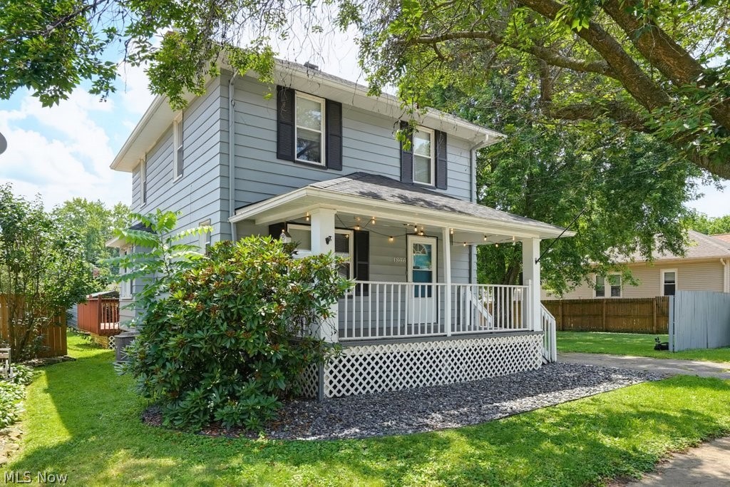 This property has A LOT to offer ... including an EXTRA LOT!  Whether you're searching for your first home, your next investment opportunity, or a property filled with timeless character, this nearly 100-year-old Colonial in Akron's Goodyear Heights neighborhood is one you won't want to miss. Offering 3 bedrooms, 1.5 baths, and classic charm, this home blends vintage character with valuable updates, including a newer roof and central air conditioning.  Step inside to discover beautiful hardwood floors throughout the spacious living and dining rooms. The inviting living room is anchored by a cozy gas fireplace, while the bright kitchen features crisp white cabinetry, a stylish black-and-white vibe, and includes all appliances, making it move-in ready from day one.  The graceful original staircase leads to three comfortable bedrooms and a full bath, showcasing the craftsmanship and charm that make century homes so special. A convenient first-floor half bath adds everyday functionality. Outside, you'll find even more to love with a detached two-car garage, plus an attached carport that doubles as a covered patio for relaxing or entertaining. A spacious deck overlooks the fenced backyard, and the included additional lot offers endless possibilities for gardening, recreation, expansion, or added value. The basement features glass block windows, a dedicated laundry area, generous storage, and is ready for your finishing touches to create additional living or hobby space.  Conveniently located near parks, shopping, dining, schools, and major highways, this home offers incredible potential for homeowners looking to build equity, investors seeking their next opportunity, or anyone who appreciates the warmth, craftsmanship, and personality that only a century-old home can provide. Don't miss your chance to own this Goodyear Heights gem!