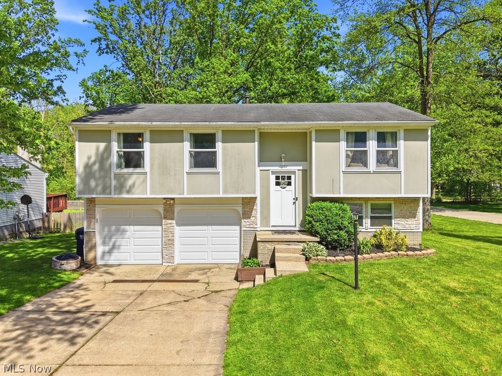 Welcome to your opportunity to live like you're on vacation in the highly desirable Aurora Shores community! This well-maintained 3-bedroom, 1.5-bath bilevel offers a move-in ready and well thought out layout in the Twinsburg City School District.  The main level features new flooring and an open and functional floor plan.  The spacious living room, dining room and kitchen create a comfortable flow for everyday living.  Glass doors off the dining space leads to a deck overlooking a private backyard, a perfect setup for relaxing or entertaining friends and family.  Three good sized bedrooms and a full bathroom complete the main level.  The lower level adds more flexibility with a large living room and convenient half bath.  Whether you need additional living space, a playroom, office or workout area, this space offers endless possibilities!  The laundry room is just off the entry to your 2-car garage for added convenience. Aurora Shores features a 300+ acre lake for all of your water activities; fishing, boating, skiing, tubing, swimming & more!  Also including multiple pools, beaches, playgrounds, a baseball field and volleyball/tennis/pickleball/basketball courts, there's a little something for everyone. Don't miss out on your chance at this fantastic property in this incredible neighborhood! Schedule your private showing today!