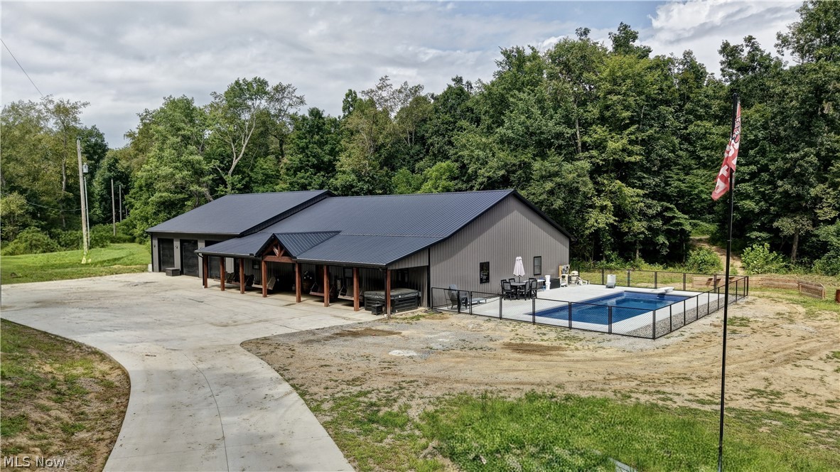This is a rare opportunity to own a brand new Barndominium, built by Abraham Builders, on 17.53 acres, with a pond, trails and deer blind on the property.  A concrete driveway leads you to the home a covered 10 x 60 front porch greets you and a hot tub.  The home features 5 bedrooms, 3 full baths, 3000 sq. ft.  Walk-in the entryway and you are met with an open concept, 10' ceilings.  The dining area features built-in cabinets, for coats, shoes and bookbags.  The living room features a built-in electric fireplace.  The kitchen has Kraft Maid custom cabinets, granite countertops and backsplash, all stainless steel appliances are included, refrigerator, stove and microwave.  There is a large pantry off the kitchen with shelving.  The primary bedroom features a walk-in closet and primary bath with stand-up shower.  Four more bedrooms with large closets and two full baths, one bath with a stand-up shower and one with a bathtub/shower combo.  Vinyl plank flooring throughout.  The laundry with washer and dryer leads you out to the 2500 sq. ft. 3 stall garage, heated and a/c. A new inground, fenced in, 16x40 pool, built by Casey All American Pools with automatic cover.  Septic installed by RTC, and well installed by Yoder Drilling.  Utility averages:  $300/electric AEP; propane tank is 500 gallon; Spectrum Internet $50/ Trash is Kimble $75 per quarter.