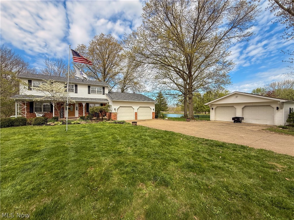 NEW ROOF! Recently finished basement! An exceptional opportunity in Valley City, this 5.55-acre property spans two parcels and features a private lake, offering a rare combination of space, privacy, and natural beauty. Enjoy a tranquil setting with convenient access to local dining, shopping, parks, and community events, all within the Buckeye Local School District. This unique property features a 2-car attached garage, a 2-car detached garage, and an additional outbuilding perfect for a she-shed, man cave, or workshop. A private small lake creates a serene, picturesque backdrop that truly sets this home apart. Inside, the updated kitchen showcases granite countertops, white cabinetry, hardwood flooring, recessed lighting, stainless steel appliances, and a new stove (2024). The kitchen opens to the family room with hardwood floors and a brick wood-burning fireplace, creating an inviting space for everyday living and entertaining. Just off the family room is the sunroom overlooking the lake, offering a peaceful spot for morning coffee or evening relaxation, while the deck extends your living space outdoors to enjoy the surrounding acreage. Formal living and dining rooms provide additional space for gatherings, while the first-floor laundry, half bath add convenience and functionality. Upstairs, the primary suite includes a private bath, along with three additional spacious bedrooms and a second full bath. The recently finished basement adds valuable additional living space, perfect for a rec room, home office, or gym. Major updates include a brand new roof (April 2026) and a furnace installed in 2022, offering peace of mind for years to come. A rare opportunity to own acreage, water views, and privacy in historic Valley City—while still being close to everything.