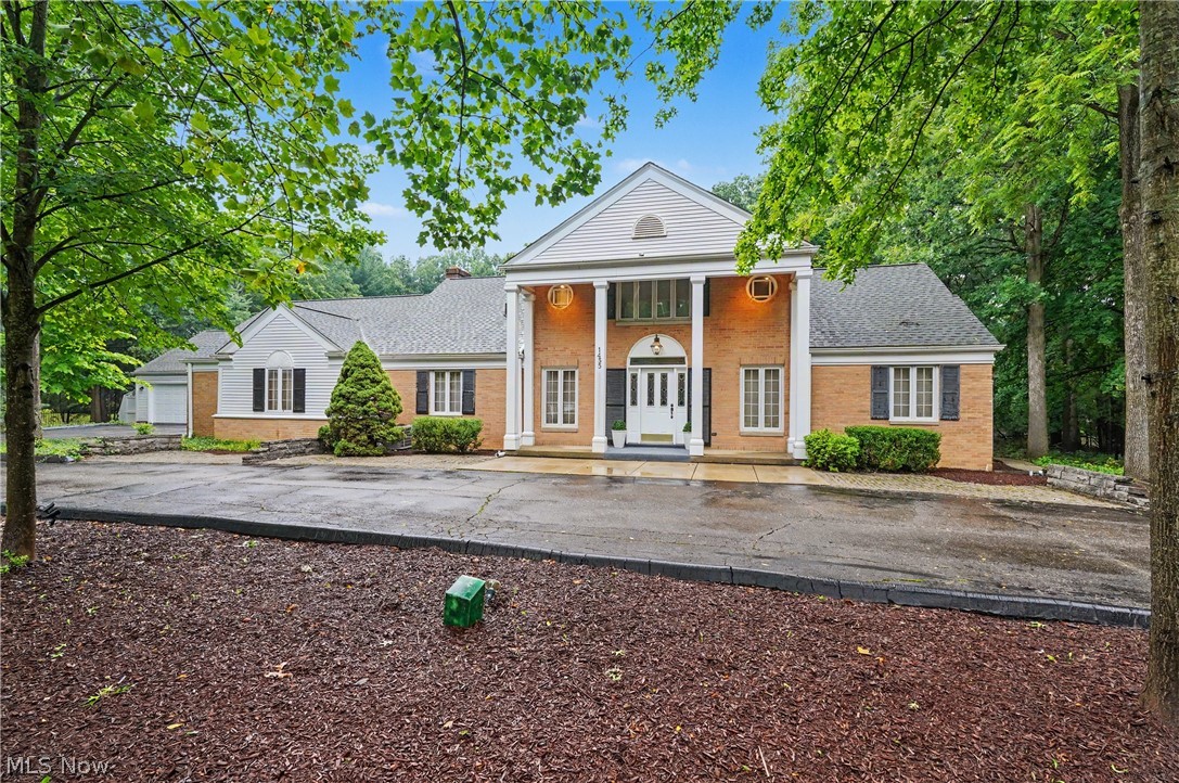 Welcome to 1455 Woodland Ln, a one-of-a-kind estate located in the highly desirable Silver Lake community. Situated on a private 2.18-acre lot at the end of a quiet dead-end street, this stunning 4-bedroom, 2 full baths, 2 half baths colonial offers 4,842 sq. ft. of above-ground living space plus an additional 418 sq. ft. of finished basement space. Fully fenced and surrounded by mature landscaping, this property offers privacy, elegance, and functionality. As you approach the home, you are greeted by a beautiful half-circle driveway with additional parking and an impressive 5-car garage. Step inside the grand marble foyer and appreciate the quality and character throughout the home. To the right is a spacious front sitting room, while the left features a private office area. The main level offers a large family room with a marble fireplace that opens into the kitchen and living areas. The unforgettable living room is the heart of the home, featuring soaring vaulted ceilings and a statement fireplace that creates a remarkable atmosphere. The dining room flows into the updated kitchen, complete with newer appliances, white countertops with gold accents, and a fireplace adding warmth and charm. Off the kitchen is a gorgeous 4-season room with access to one of the garage spaces. The main level also includes two half bathrooms and a laundry room. Upstairs, the expansive primary suite features a lofted area overlooking the living room below and includes a private bathroom. Three additional bedrooms and another full bathroom provide plenty of space for family and guests. The finished lower level includes a large recreation room and endless storage options. Outside, enjoy your private backyard retreat with walking paths throughout the property and a large shed equipped with electricity and heat, perfect for a workshop or hobby space. This exceptional Silver Lake estate offers incredible space, privacy, and unique architectural details. 1455 Woodland Ln is unlike any other.
