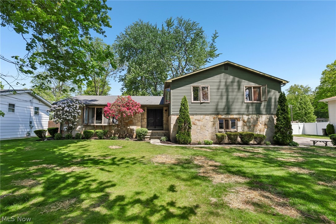 Welcome to this beautifully maintained 4-level split in Ashtabula Township! Step through the front door into a welcoming foyer that sets the tone for the warmth and space this home has to offer. To the left, the spacious living room features large bay windows that fill the space with an abundance of natural light. Just beyond, the dining room provides the perfect setting for hosting family dinners and gatherings, seamlessly flowing into the kitchen, complete with ample cabinetry and plenty of storage space. Upstairs, you’ll find four generously sized bedrooms along with the main full bathroom. The primary suite offers a spacious walk-in closet and a private en suite bathroom for added comfort and convenience. The lower level features a cozy family room centered around a charming fireplace, making it the ideal spot for relaxing evenings or game nights with family and friends. This level also includes a convenient half bathroom, laundry room, and direct access to the attached two-car garage. The partially finished basement adds even more versatile living space, complete with a large storage closet and endless possibilities for a home office, recreation room, workout area, or additional hangout space. Step outside through the kitchen’s sliding glass doors to enjoy the back deck overlooking a large fenced-in backyard—perfect for kids, pets, entertaining, or simply enjoying the outdoors. Don’t miss your opportunity to make this wonderful home your own—schedule your showing today and imagine the possibilities for your future here!
