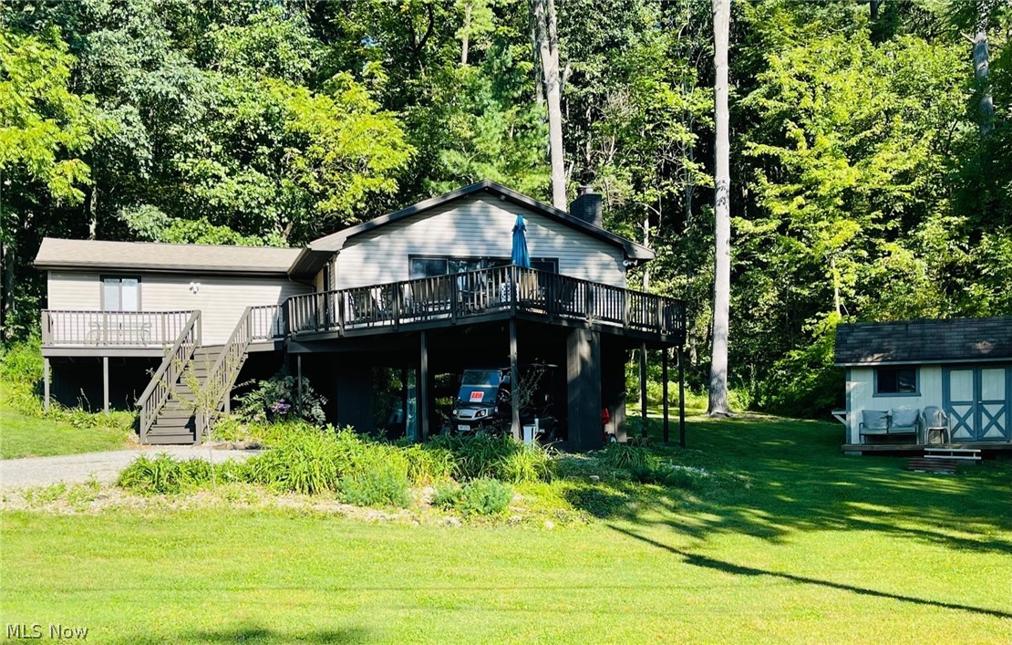 ATWOOD LAKE LIVING:  Welcome home to this 3 bedroom, 2 full bath raised ranch located in the North Shore Allotment.  The first floor features a nice layout with a vaulted ceiling and an open concept design.  Fully equipped kitchen.  Great room with a wood burning fireplace.  Three bedrooms with one full bath.   
The finished walk-out lower level features an oversized living room/ recreational room, laundry room, full bath and a wet bar.  The large deck on this home is great for seasonal Atwood Lake views and perfect for entertaining.  New air conditioning unit installed 9/2022 , New shingles and well in 2015, new vinyl siding in 2021.   This home offers a private dock and located in a prime location.  Schedule your private showing before this home is gone.