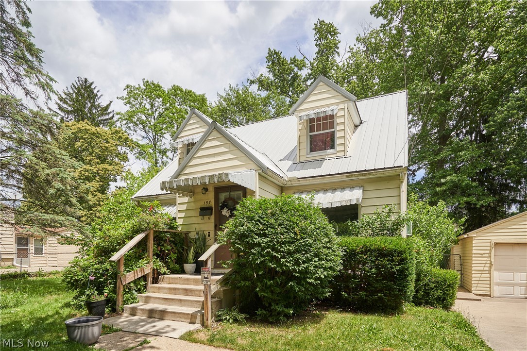 Welcome to 157 29th Street NW in Barberton! Situated on a rare double lot, this charming Cape Cod offers plenty of space both inside and out. The inviting interior blends classic character with thoughtful cosmetic updates completed over the past several years, creating a warm and move-in ready atmosphere.

The spacious living room is filled with natural light and features carpeting with original hardwood floors underneath on the main level. The eat-in kitchen offers ample cabinet and counter space, while the updated full bath adds modern appeal. The remainder of the main level I finished out with two spacious bedrooms. Upstairs, you'll find two additional generously sized bedrooms, a convenient half bath, and built-in storage that enhances both functionality and charm.

Outside, enjoy the benefits of a detached one-car garage, oversized yard, and mature trees that provide privacy and room to entertain, garden, play, or simply relax. A newer metal roof adds long-term value and peace of mind.

Conveniently located near schools, parks, shopping, and major highways, this property offers an excellent opportunity for first-time buyers, growing families, or anyone looking for extra outdoor space. Don't miss your chance to make this Barberton home your own!
Call your favorite agent today!