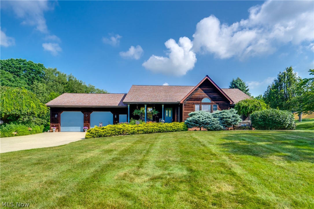 Welcome to this stunning custom home set on 2 picturesque acres, offering the perfect blend of quality craftsmanship, comfort, and exceptional outdoor living. From the soaring cathedral ceilings to the beautiful redwood siding, every detail makes a lasting impression. The inviting living room is the heart of the home, featuring a gorgeous floor-to-ceiling stone fireplace that creates a warm and welcoming atmosphere. The spacious eat-in kitchen provides plenty of room for everyday dining and entertaining, while the formal dining room is perfect for hosting holiday gatherings and special occasions. Throughout the home, you'll find beautiful solid oak doors and trim that add warmth and timeless elegance. The expansive primary suite is a private retreat complete with a luxurious Jacuzzi tub for ultimate relaxation. The partially finished walk-out basement offers additional living space and opens to a lovely stone patio. Step outside to enjoy your own backyard oasis with a heated in-ground pool, a convenient storage shed for pool equipment and maintenance supplies, and a spectacular two-tier deck overlooking the beautifully landscaped 2-acre property. Car enthusiasts and hobbyists will appreciate both the large attached heated garage and the detached garage featuring a built-in workbench. This exceptional property combines privacy, quality craftsmanship, and resort-style amenities, making it a truly one-of-a-kind place to call home.