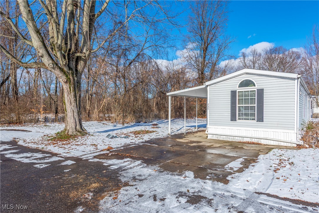 Enjoy affordable living in Amherst Trails Mobile Home Park with this well-maintained 2-bedroom, 1-bath home featuring an open floor plan that creates a comfortable, spacious feel. The dining and living room areas offer newer flooring, adding a fresh, updated touch. Relax on the covered porch, perfect for enjoying your morning coffee or unwinding at the end of the day. All appliances stay, making this home truly move-in ready. This is an end unit on a dead end street...visualize bigger lot surrounded by trees. Located in the Firelands School District, this is a great opportunity to enjoy homeownership at a lower cost than renting while still being close to shopping, dining, and everyday conveniences. Also a shed for your tools and grill etc.