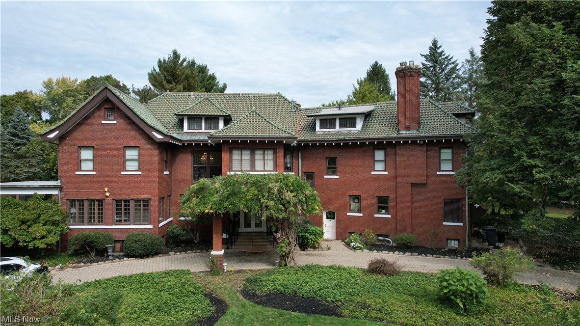 Welcome to 16390 South Park Blvd a captivating blend of history and modern comfort awaits you. Built in 1905 by Jeffrey T. Horace, this residence has undergone thoughtful changes over the years to enhance functionality while retaining its original magnificence. Nestled on almost 3 acres of meticulously landscaped gardens, this home boasts red brick elevations, brick walkways, and a circular driveway with front porte cochere, preserving the original detailing that defines its classic charm. Inside the main residence, a formal living room, a classic library with picturesque views, a sun room, 7 bathrooms, and 8 bedrooms (some with Jack and Jill bathrooms) offer ample space for residents. The kitchen is a haven for avid cooks, updated  with stainless steel appliances, 6 burner gas stove top, adjoins an adorable breakfast nook with built in shelves and entry to the side yard. A separate butler's pantry leads to a stately dining room adorned with a fireplace a perfect setting for elegant gatherings. Throughout the residence, ornamental molding adds a touch of elegance.

The property features six original fireplaces, each a testament to the timeless craftsmanship and character embedded in the home. The grandeur is further accentuated by a sweeping, curved central staircase, a focal point that exudes sophistication. The finished third floor provides an additional level of living space with three bedrooms, a full bath, and office. The lower level of the residence boasts a carpeted recreation room with track lighting, Proximity to the recreation room, a wine cellar provides a dedicated space for the storage and enjoyment of your wine collection.  

The carriage house offers cozy guest quarters with a country-style kitchen, living room, full bath and two comfortable bedrooms. A greenhouse with attached potting shed, an in-ground pool, tennis court, and chicken coop provide further amenities.
