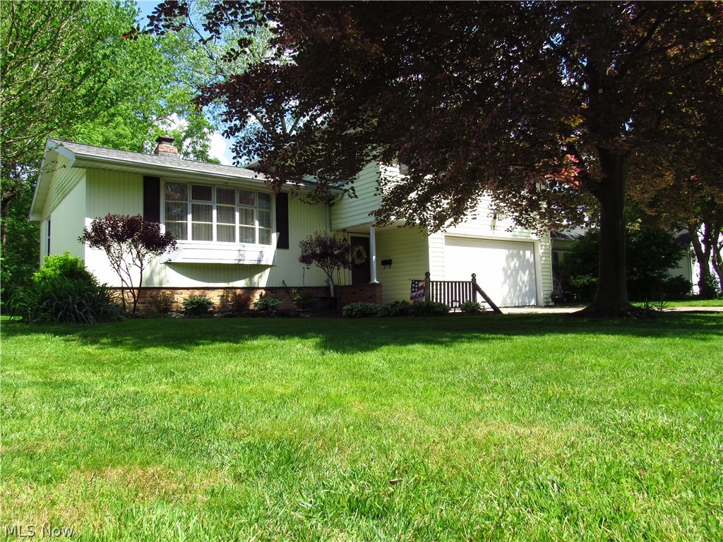 Be first or be sorry! Four bedroom, three bathroom Split Level with basement and two car attached garage located on a quiet street! Updated eat-in kitchen with newer stainless steel appliances and granite look-alike countertops. Formal dining room and living room have volume ceilings. Family room features a half bath and door leading to a three season sun room with skylights and a wood burning stove. Owner suite has half bathroom. Basement has recreation room, big workshop, storage, shower stall and glass block windows. Hardwood floors in most rooms! Two car garage. First floor laundry room! Neutral colors throughout! Close to shopping and schools! Roof (complete tear off) 2018. Hot water tank 2014. Windows (appox.) 2011. Includes 1 Year Cinch home warranty!