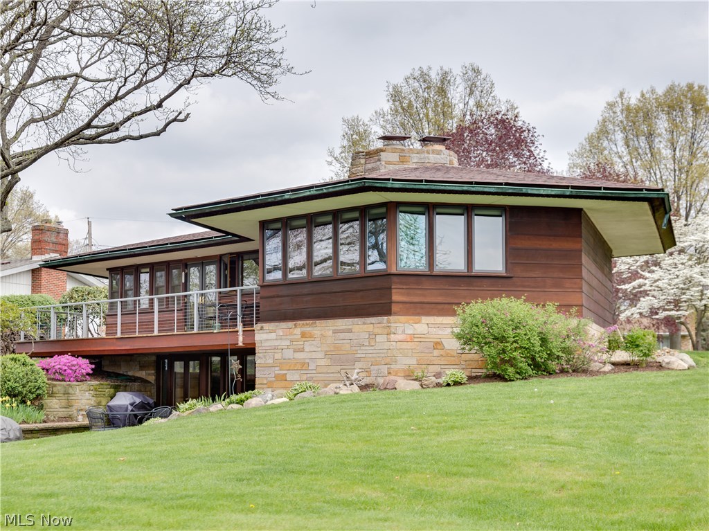 Outstanding Portage Lakes lakefront on main chain of lakes!!! Architecturally inspired redwood ranch on quiet dead end street (.5 acre lot)* Airy, flowing floor plan with abundance of natural light from walls of windows & picturesque views of East reservoir from all rooms* Approx. 3196SF including finished walkout, 3-4 bedrooms, 2.5 baths, 2 fireplaces & generous heated 2.5 car garage* Great room w/built in seating, gas log FRPL & built in shelving* Formal dining with built in shelves & seating* Eat in kitchen (2012) w/cherry cabinets, granite counter top, stainless appliances (refrig, induction electric range, DW, microwave) & disposal, ceramic floor* Master w/built ins & updated bath (2012) w/Corian counter top* Bedrooms 2 & 3 w/ built ins (can be one large room or 2 with sliding wall)* Mega storage/pantry area* Open staircase to walkout lower level family room ideal for entertaining ; Family room wrapped around huge sandstone wood burning fireplace plus spacious rec room with heated