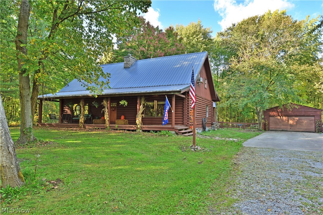 Pioneer in style with this fabulous log cabin home, located on almost two acres in North Jackson! This stunning home has been updated throughout with modern styling cues and tons of craftsmanship. Masterful woodwork fills the home as its tall ceilings form a towering peak over the combined great room and kitchen. A nearby a beautiful stone fireplace rises to greet a second story overlook as lush carpets run below. Rustic barnwood styled trim accents the kitchen while bar top seating joins a large island. Poured epoxy countertops glisten amongst the stainless appliances and glass tile backsplash. Casual dining looks on with adjacent home office space as tall windows provide scenic outdoor views. Down the first-floor hall, an updated full bath in 2019 with stone trimmed tub and private shower join a pair of spacious bedrooms with great closet space and first-floor laundry with an all-in-one washer/dryer staying. Up the winding staircase, a relaxing landing reveals an additional 2019 upda