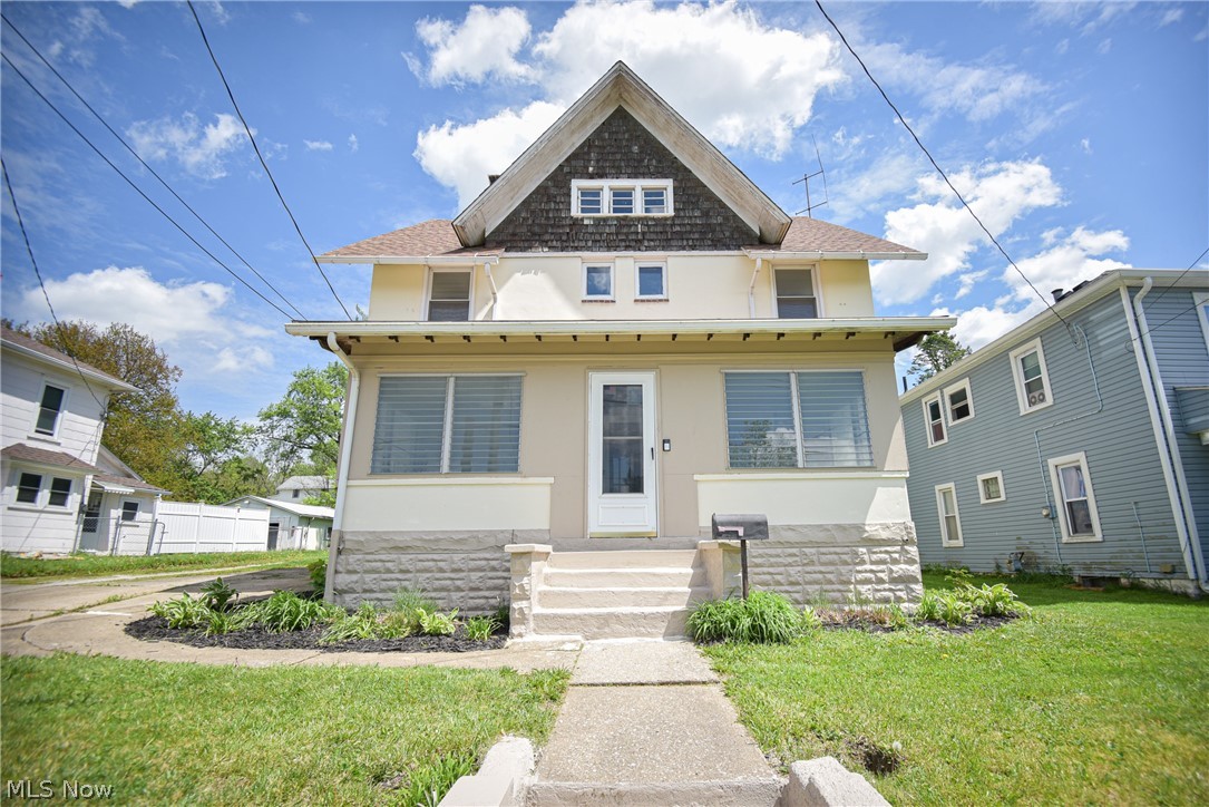 Full of charm and character, this 4-bedroom, 1.5-bath colonial offers timeless appeal with thoughtful updates throughout! A spacious enclosed front porch welcomes you in and provides the perfect spot to relax and unwind. Inside, the front door opens onto a large living room with a cozy fireplace and brick surround, flowing seamlessly into the oversized dining room—ideal for entertaining and family gatherings. Decorative beadboard accents add warmth and character throughout the dining room and staircase, while the high ceilings continue throughout the home, enhancing the spacious feel. The updated kitchen showcases new cabinetry, countertops, sink, and appliances that stay, including a brand-new microwave, and new flooring that leads to the convenient mud room, as well as an updated half bath. Upstairs, you’ll find the primary bedroom with two closets, three additional bedrooms, and an updated full bath complete with a walk-in shower, flooring, vanity, and charming decorative beadboard detail. The walk-up attic offers incredible potential for an additional finished bedroom suite, home office, or playroom—just waiting for your imagination! The basement provides a laundry area along with plenty of storage space. Outside, enjoy the fully fenced backyard and the convenience of a 2-car tandem garage with attached outbuilding. This charming home blends classic character with modern updates and is ready for its next owner to move right in! Additional updates include fresh paint throughout, new living room ceiling fans, new AC installed, and kitchen lighting; the roof was redone in 2020.