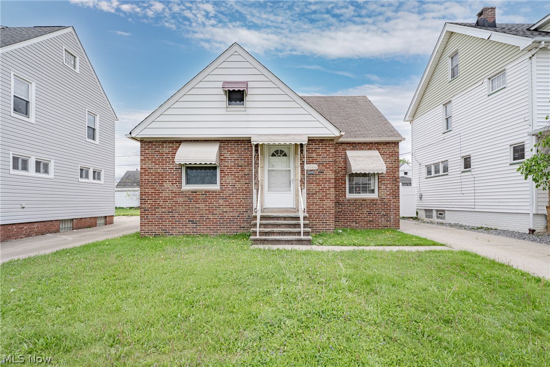 Welcome to 10800 Vernon Ave in Garfield Heights, a charming Cape Cod with thoughtful updates and inviting curb appeal. Sandstone accents frame the front entry, creating a warm first impression. The front door opens into a foyer that flows into a spacious living room with hardwood flooring and natural light. The updated kitchen is located just beyond and features a tile backsplash and newer cabinetry. Updated flooring adds a clean, refreshed look. The main level includes two bedrooms, both with hardwood flooring and neutral paint. The rear bedroom offers access to the back door. A full bathroom with a tile shower surround completes the first floor. Upstairs, a spacious third bedroom provides additional living space. This area includes built-ins, wood flooring, and ample storage. The full basement is finished and expands the living area. It includes a large recreation room, a laundry and utility space, and a second full bathroom. Outside, a covered back porch offers a comfortable place to relax. A two-car garage provides convenient parking and additional storage. This home offers a functional layout, updated features, and flexible living space in a convenient Garfield Heights location.