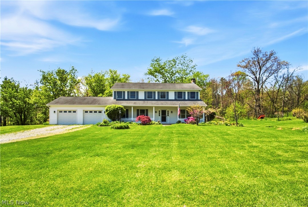 Room to live, grow, and truly enjoy country living--this spacious, one-owner home in the Tri-Valley LSD is being offered to the market for the very first time! Custom built in 1995 and meticulously maintained, this 6 bedroom, 2 full baths & (2) 1/2 baths property sits on 2.08 acres and offers the space and features today's buyers are looking for! Start your mornings on the covered front porch with a coffee on the swing, or unwind out back, watching the sunset, on the deck featuring all new flooring boards. A side concrete patio provides the perfect setup for a future hot tub. Inside, the kitchen is equipped with stainless steel appliances, Corian countertops, and beautiful cherry cabinetry, along with an abundance of storage throughout the home. A main floor bedroom offers flexibility for a home office or guest space, while the large first-floor laundry/mudroom adds everyday convenience right off the garage. The lower level includes walk-out access, a fruit cellar/tornado room, and a half bath with potential to add a shower--ready to be finished to your liking for additional living space. Stay comfortable year-round with an efficient geothermal heating and cooling system, plus enjoy the charm of a custom-built brick, wood-burning fireplace and an additional wood stove for supplemental heat.
Outdoors, you'll find a fenced garden area, blueberry bushes, and apple trees--perfect for those who love to garden or simply enjoy the outdoors. The home has also been recently power washed and is truly move-in ready. Immediate possession available! Move in before summer and the next school year too!  Preapproved buyers only.